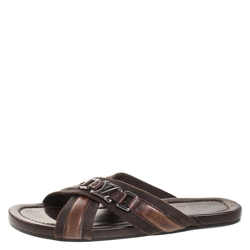 Comfort and style come together with these flat sandals from Louis Vuitton! These brown flats are crafted from leather and fabric and feature an open toe silhouette. They flaunt cross straps on the vamps and come equipped with comfortable insoles.