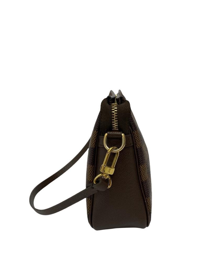 Louis Vuitton signature mini bag, made of brown Damier canvas with golden hardware. Equipped with a zip closure, internally lined in orange canvas, roomy for the essentials. Equipped with a removable handle in thin brown leather. It is in good