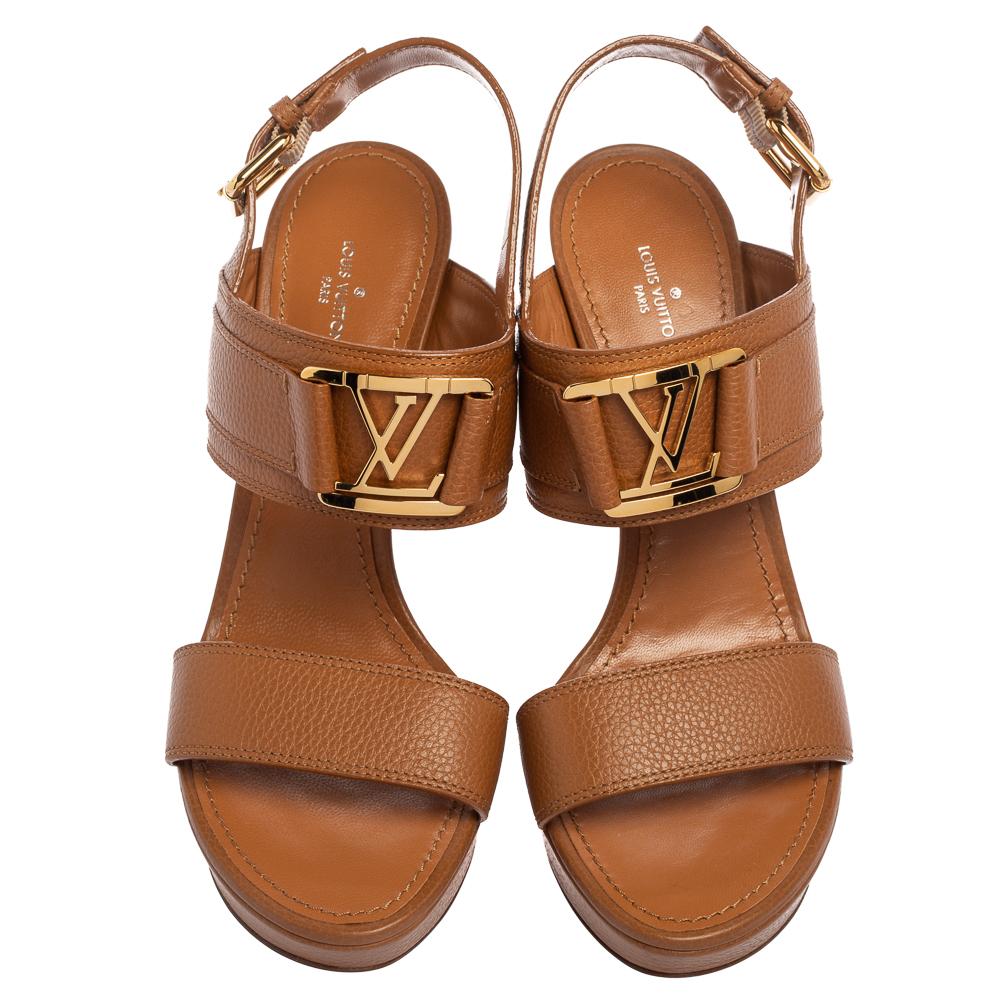 Wear these stylish sandals from the house of Louis Vuitton and channel your inner fashionista. Crafted in Italy, they are made from quality leather. They come in a lovely shade of black and feature the LV logo on the straps. They are styled with