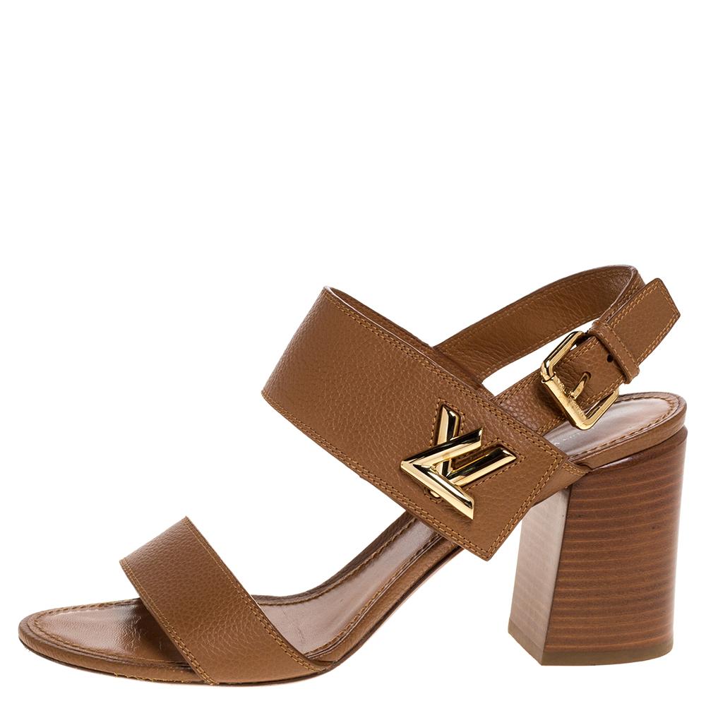 Wear these stylish sandals from the house of Louis Vuitton and channel your inner fashionista. Crafted in Italy, they are made from quality leather. They come in a lovely shade of brown and feature the Twist LV logo on the ankle straps. They are