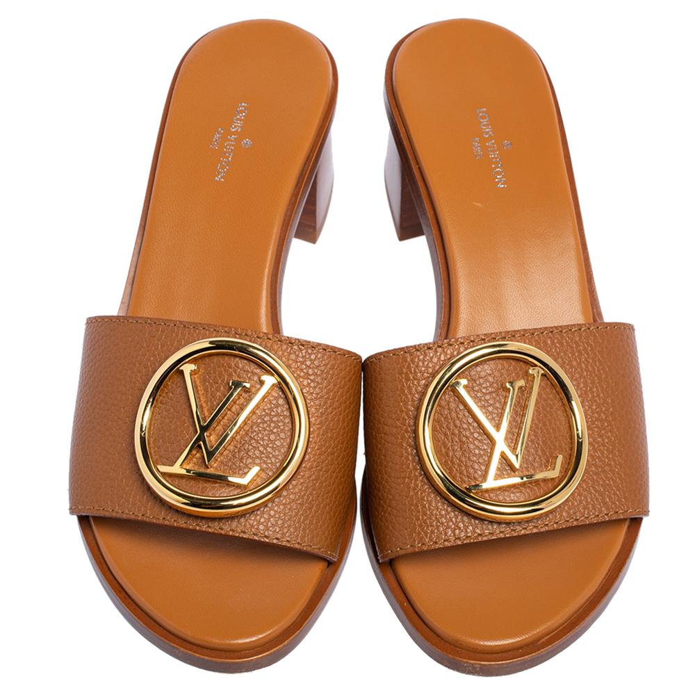 Louis Vuitton's timeless aesthetic and stellar craftsmanship in shoemaking is evident in these stunning slide sandals! They are crafted from quality leather in a brown shade and detailed with LV logos in gold-tone on the uppers. They are finished