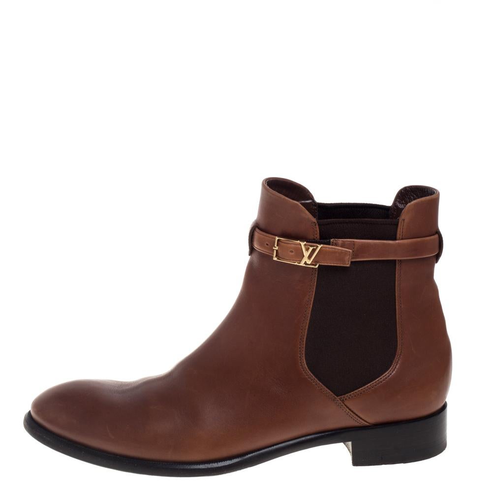 Finely crafted from leather, these ankle boots from Louis Vuitton are sleek and filled with subtle style. They bring round toes, comfy insoles, and an LV buckle belt around the ankles. Team these versatile boots with everything from skirts to