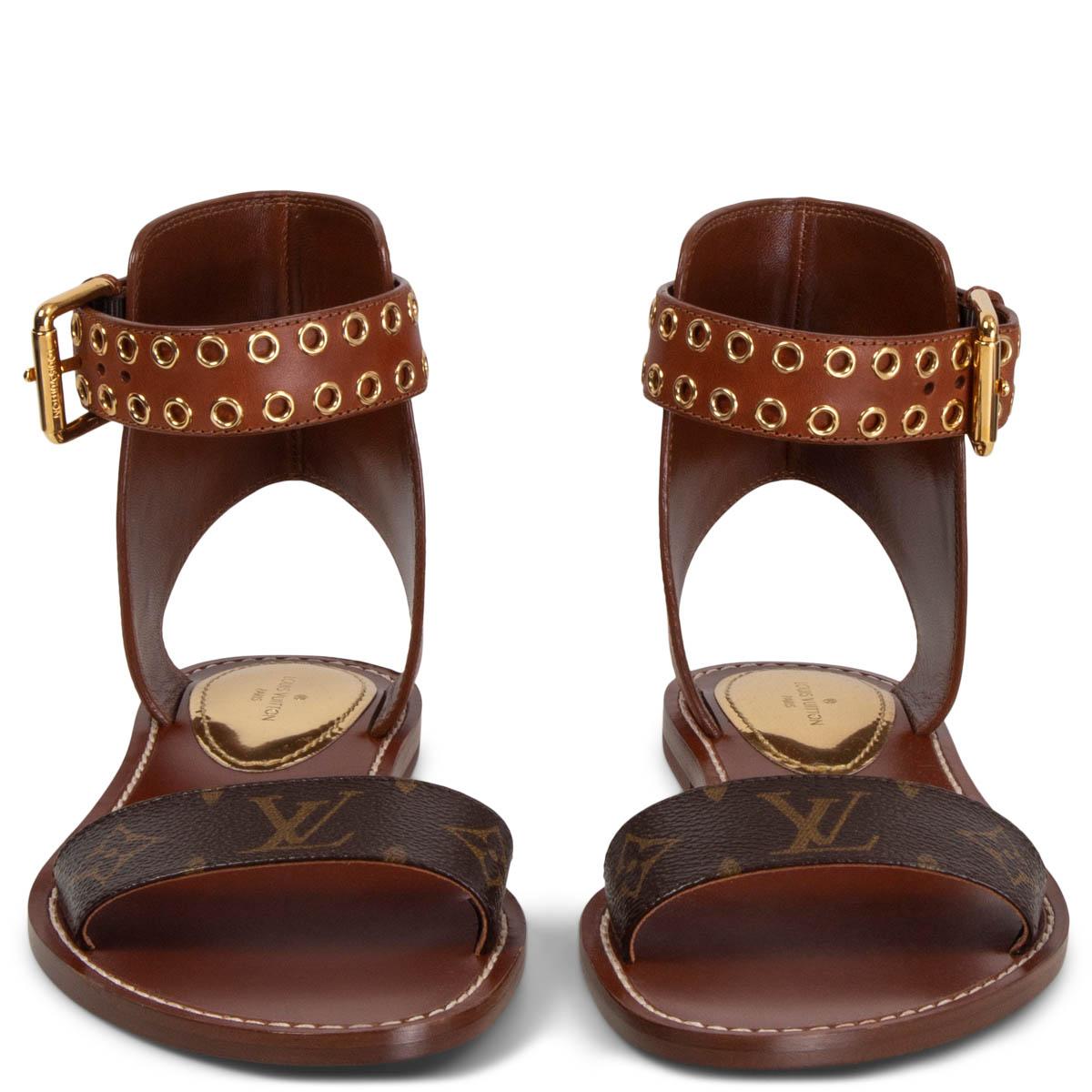100% authentic Louis Vuitton Passenger flat sandals in monogram canvas and cognac calfskin featuring gold-tone ankle-strap buckle and eyelets. Brand new. 

Measurements
Imprinted Size	38
Shoe Size	38
Inside Sole	25cm (9.8in)
Width	8.5cm