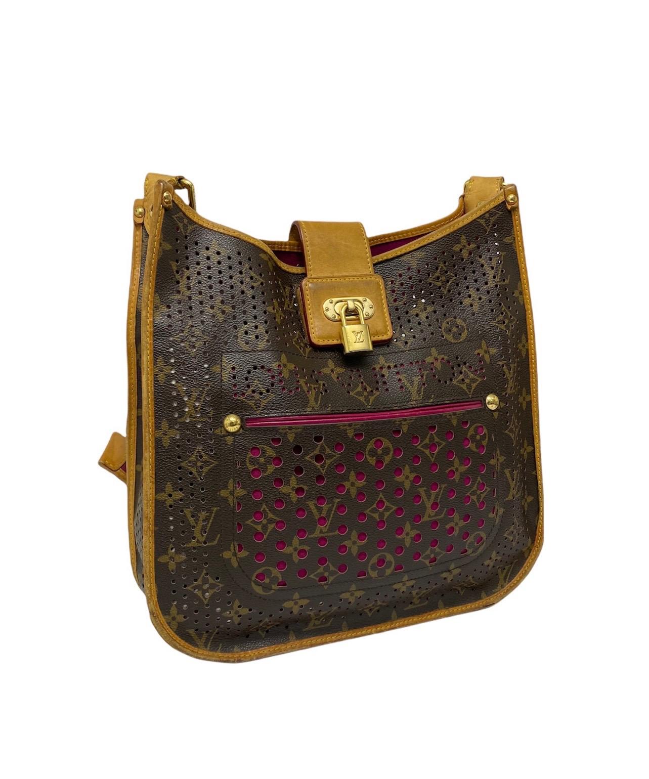 Fuchsia limited edition Louis Vuitton Musette bag with perforated monogram canvas with gold hardware.  It has a central opening with interlocking closure with a leather tongue. The interior is lined with a purple alcantara fabric. Large space on the