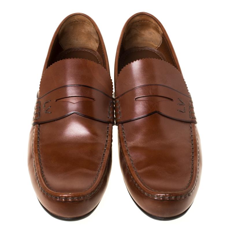 Stylish and super comfortable, this pair of loafers by Louis Vuitton will make a great addition to your shoe collection. They have been crafted from leather and styled with Penny keeper straps on the vamps. Leather insoles and rubber outsoles
