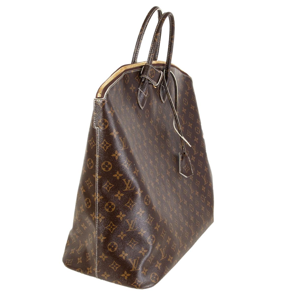 Louis Vuitton 'Lockit Voyage' carry-on bag in brown glossy Monogram Fetish with patent monogram canvas handles. Limited edition from the FW 2011 runway collection. Closes with a zipper on top. Lined in off-white matt goatskin with an open and zipper