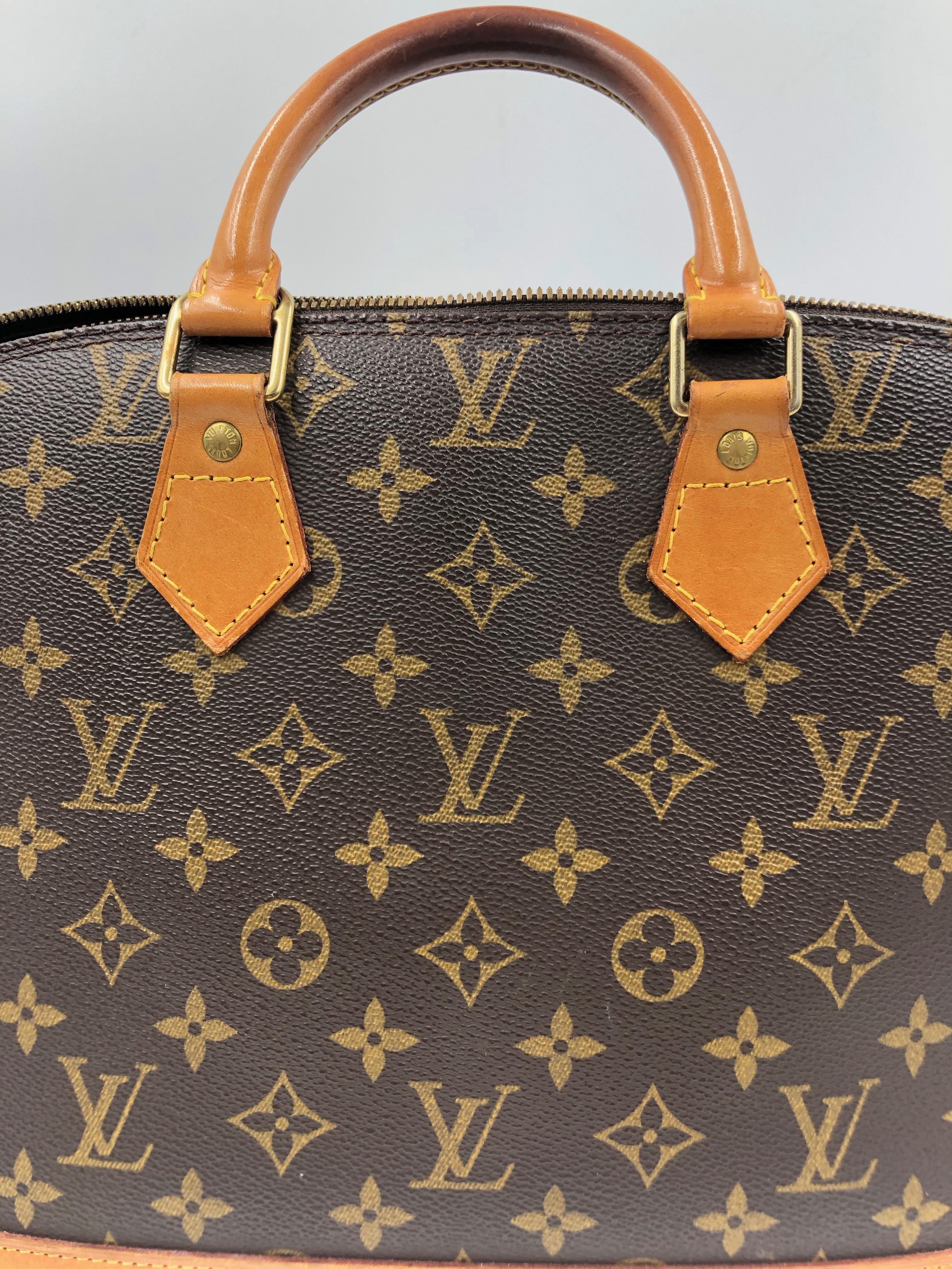 Louis Vuitton Brown Monogram Canvas Alma Bag with double zip closure. One open pocket at interior, double rolled leather handles and gold-tone hardware. No Lock

*Measurements Taken Flat*
3.25