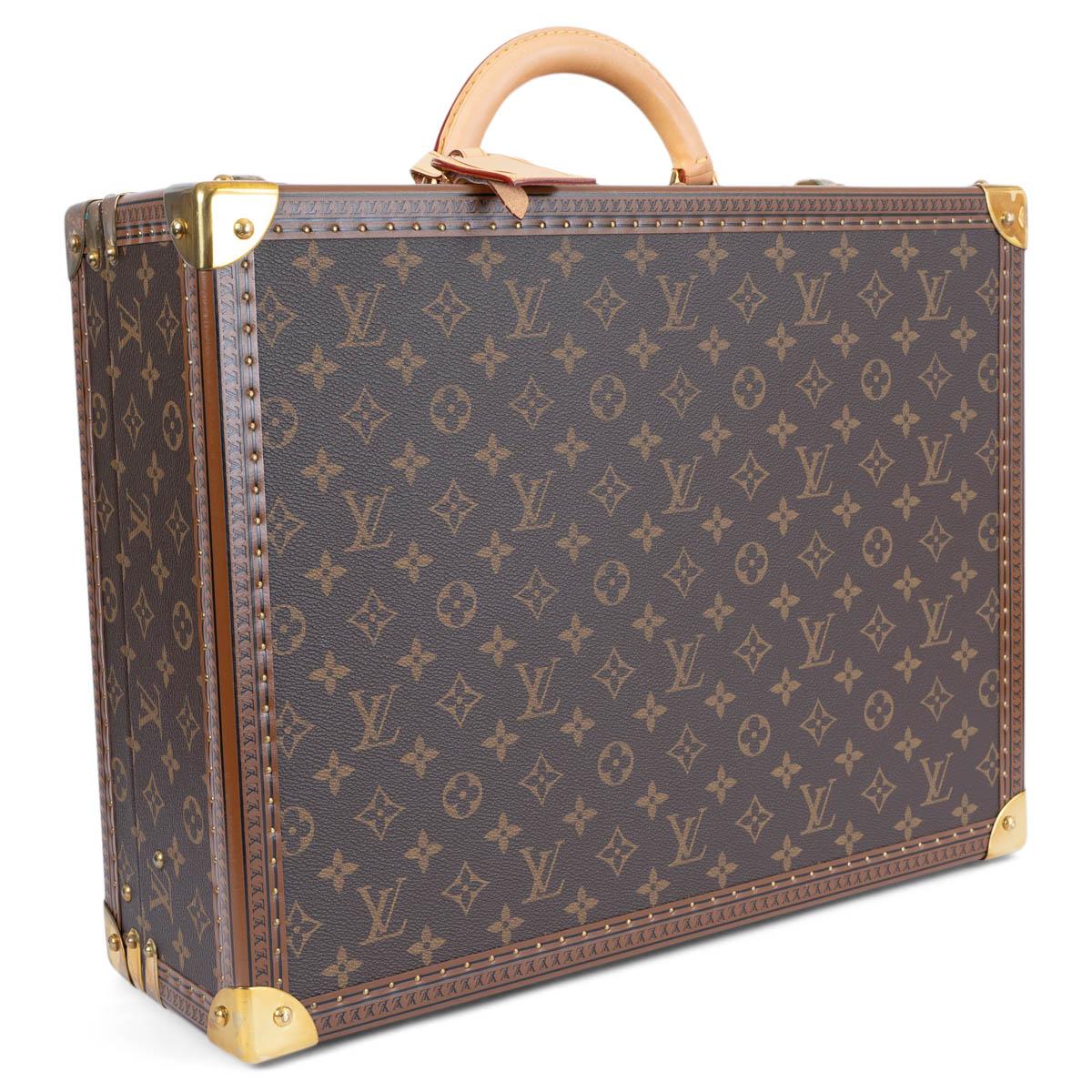 100% authentic Louis Vuitton Alzer 45 suitcase in classic Ebene brown Monogram canvas. Features a hardshell, LV stamped leather trim with brass rivets, brass corner reinforcements and a rounded leather handle. Closes with a brass lock and two