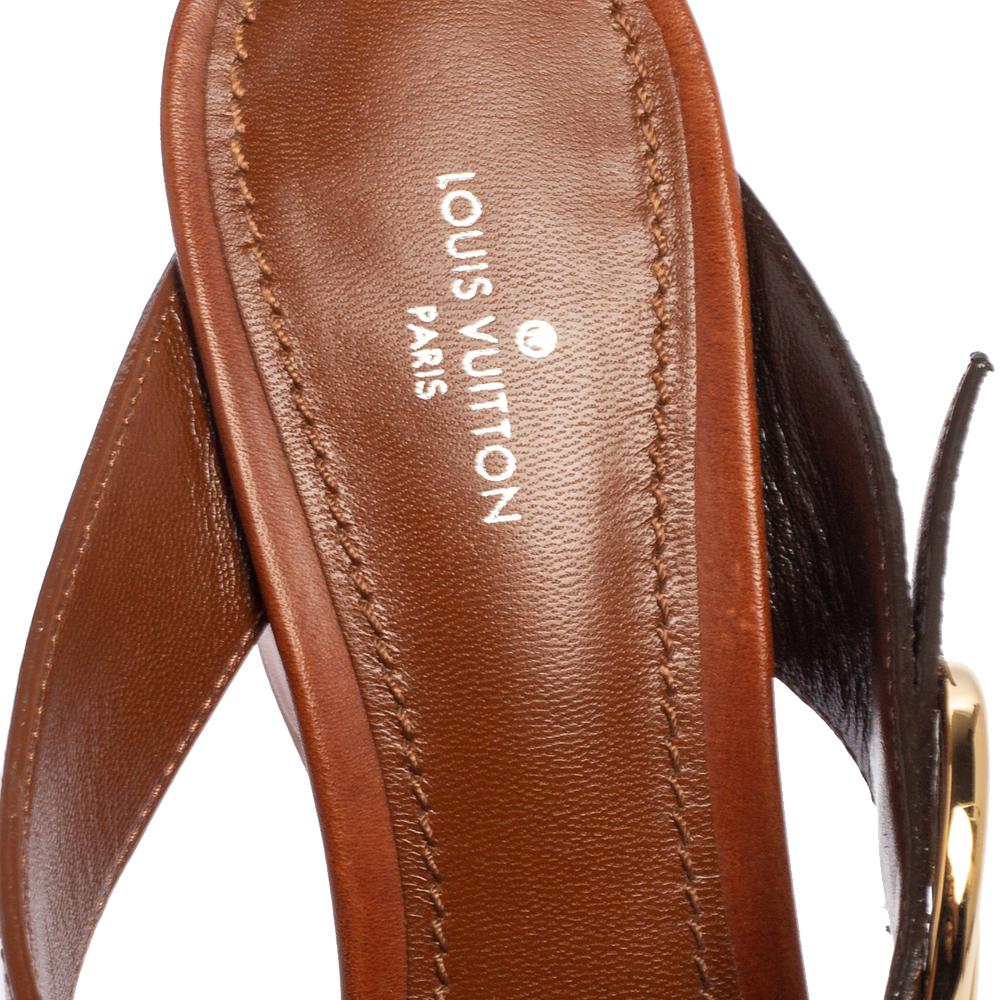 Wear these stylish sandals from the house of Louis Vuitton and channel your inner fashionista. Crafted in Italy, they are made from monogram canvas and quality leather. They come in a lovely shade of brown and feature the LV logo on the ankle
