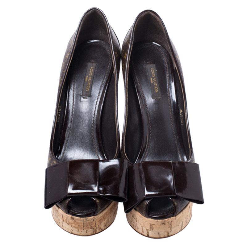 Feminine and classy, these pumps by Louis Vuitton are just irresistible. They flaunt an exterior made from the brand's signature monogram canvas and patent leather, styled with peep toes that carry large bows. The insides are leather-lined and the