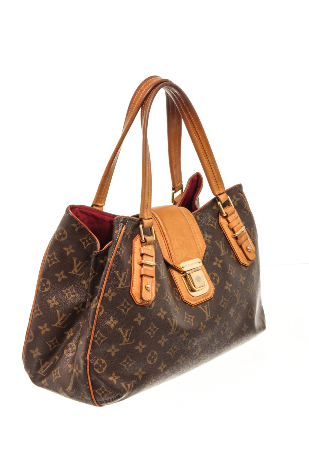 Louis Vuitton Brown Monogram Canvas Greet Shoulder Bag with features dual leather handles and trim, protective base studs, gold-tone hardware, push-lock closure opens to a red suede lining with two open compartments with a center zip compartment and