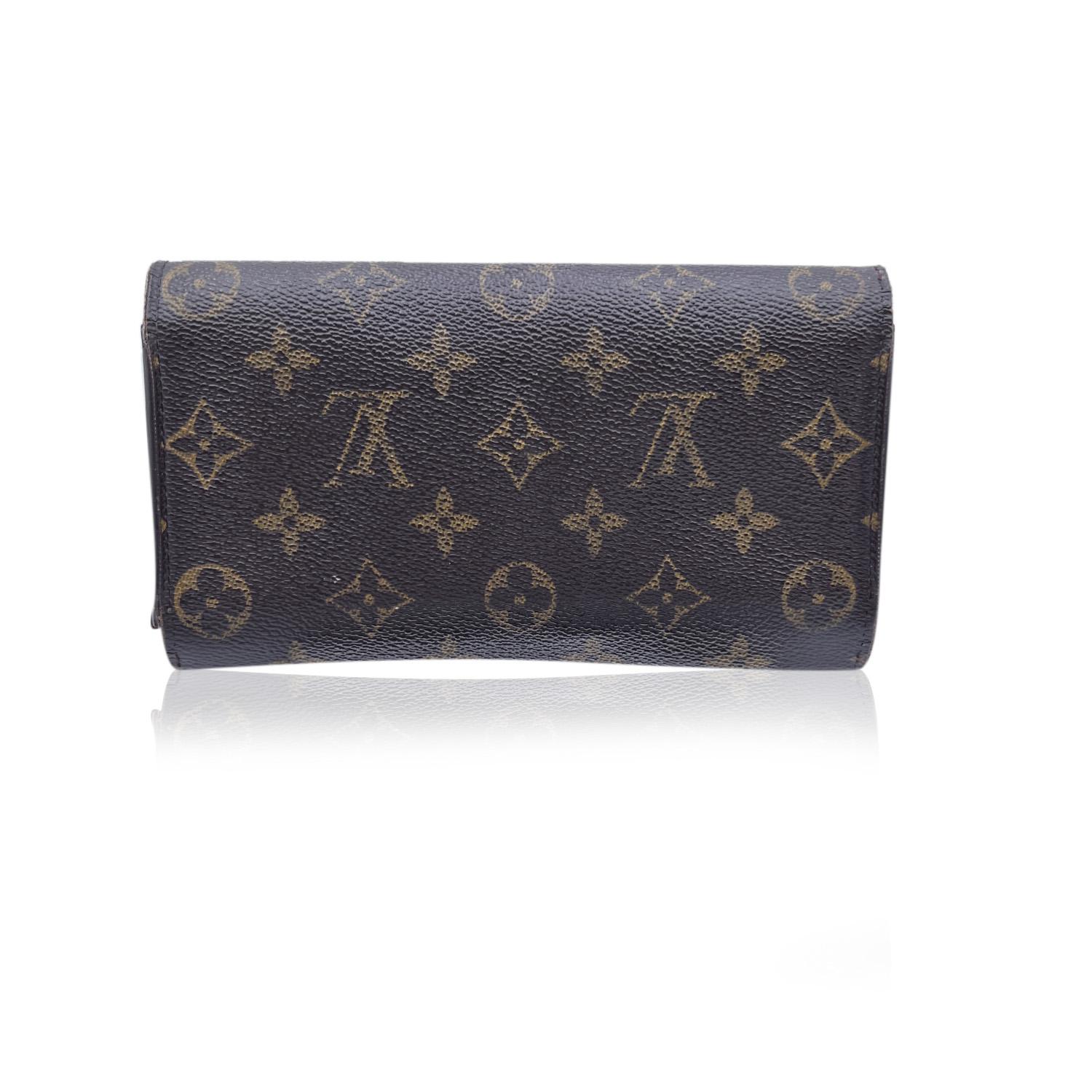 Louis Vuitton Monogram Canvas International Wallet. Monogram canvas exterior and genuine leather interior. 6 credit card slots. 2 long compartments for bills and papers. Snap closure. Pen holder. Interior coin pocket also with snap closure. Golden