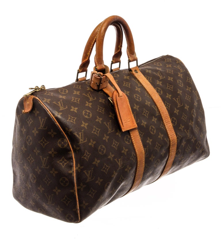Louis Vuitton Brown Monogram Canvas Keepall 45 Travel Bag with brown, signature Monogram canvas/leather, gold-tone hardware, trim tan vachetta leather, luggage tag, two rolled top handles, top zip fastening, main compartment.

88183MSC
