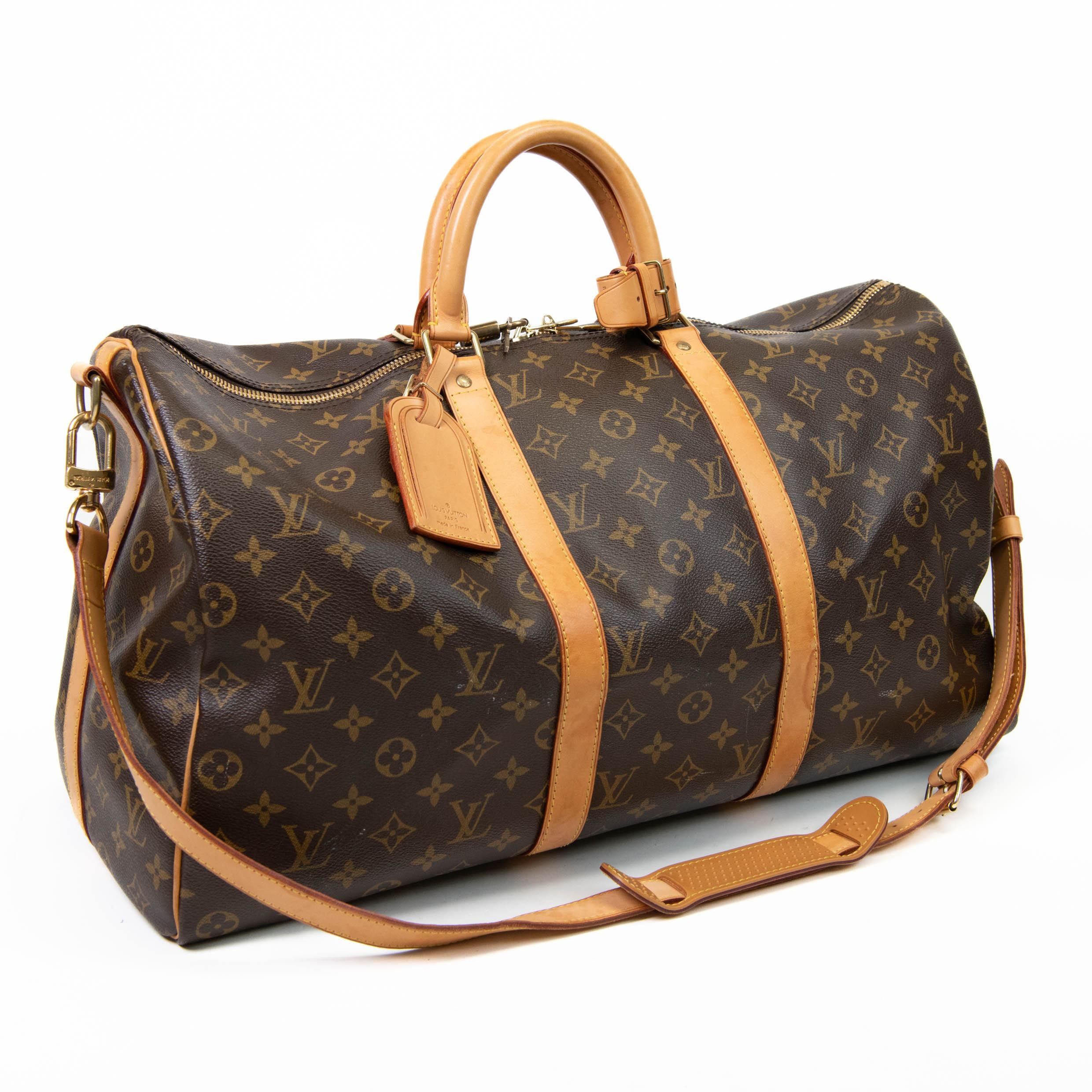 100% Authentic 

This stylish duffel is crafted of signature Louis Vuitton monogram toile canvas. This bag features vachetta cowhide leather rolled top handles, vachetta leather trim, and a detachable adjustable shoulder strap. The polished brass