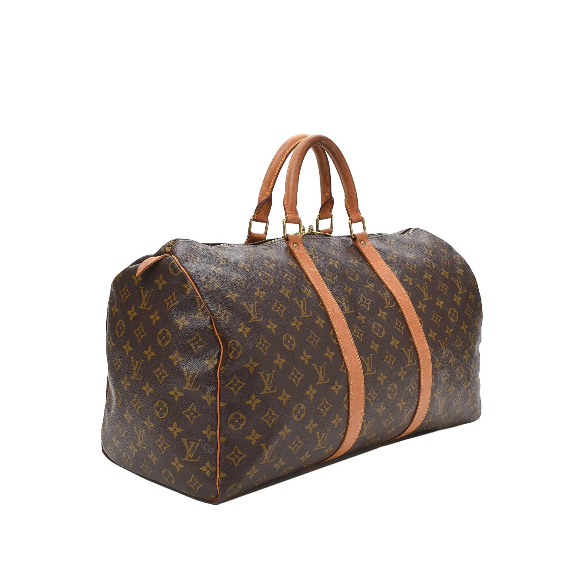 Brown and tan monogram coated canvas Louis Vuitton Keepall 50 with tan vachetta leather trim, gold-tone hardware, two rolled top handles, brown canvas interior lining and two-way zip closure at top.


73278MSC

Height: 13