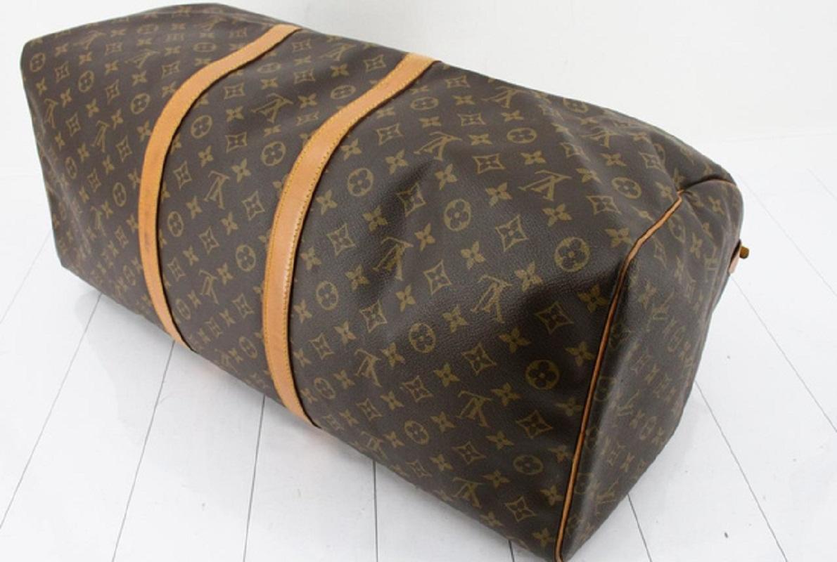 Brown and tan monogram coated canvas Louis Vuitton Keepall 60 with gold-tone hardware, tan vachetta leather trim, dual rolled handles, brown canvas lining and zip closure at top.

 

65057MSC