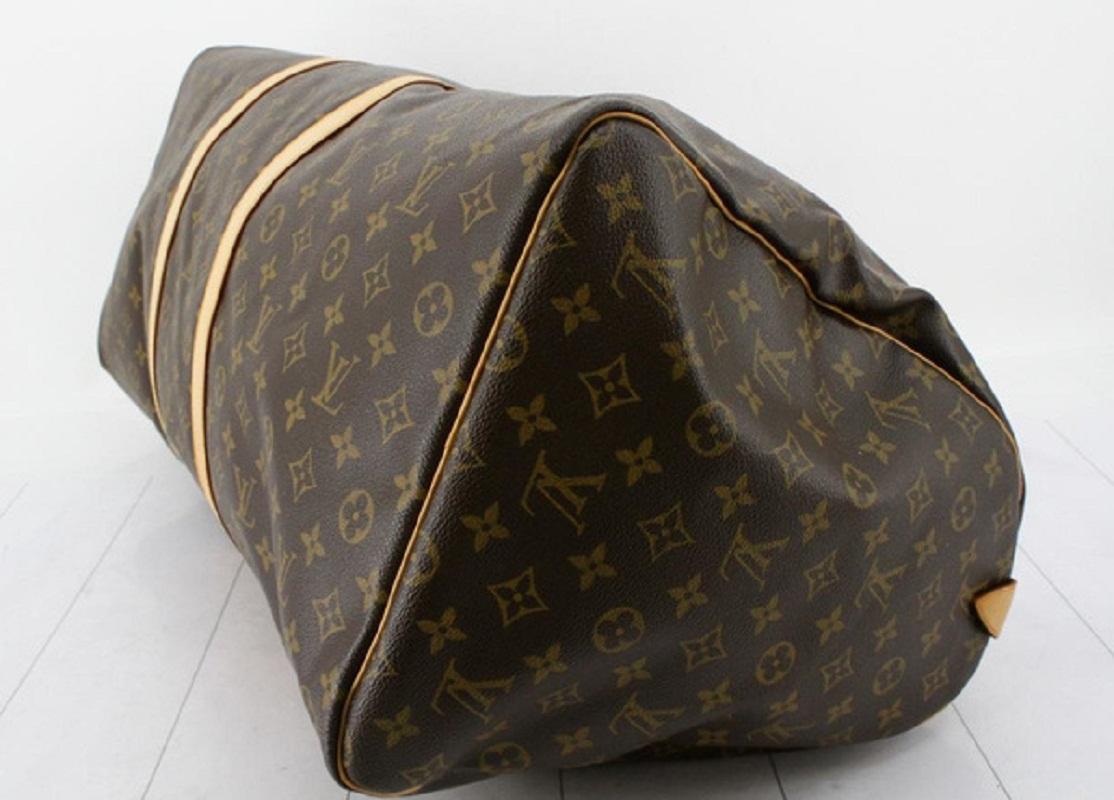 Brown and tan monogram coated canvas Louis Vuitton Keepall 60 with gold-tone hardware, tan vachetta leather trim, dual rolled handles, brown canvas lining and zip closure at top.


71940MSC