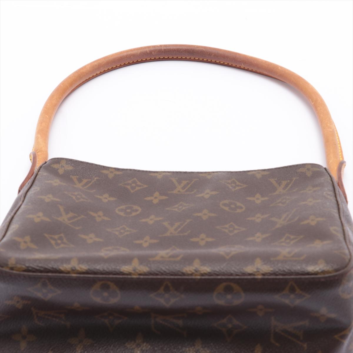 Brown and tan monogram coated canvas Louis Vuitton Looping MM with brass hardware, tan vachetta leather trim, single rolled shoulder strap, creme Alcantara lining, dual pockets at interior wall; one with zip closure and zip closure at top.


