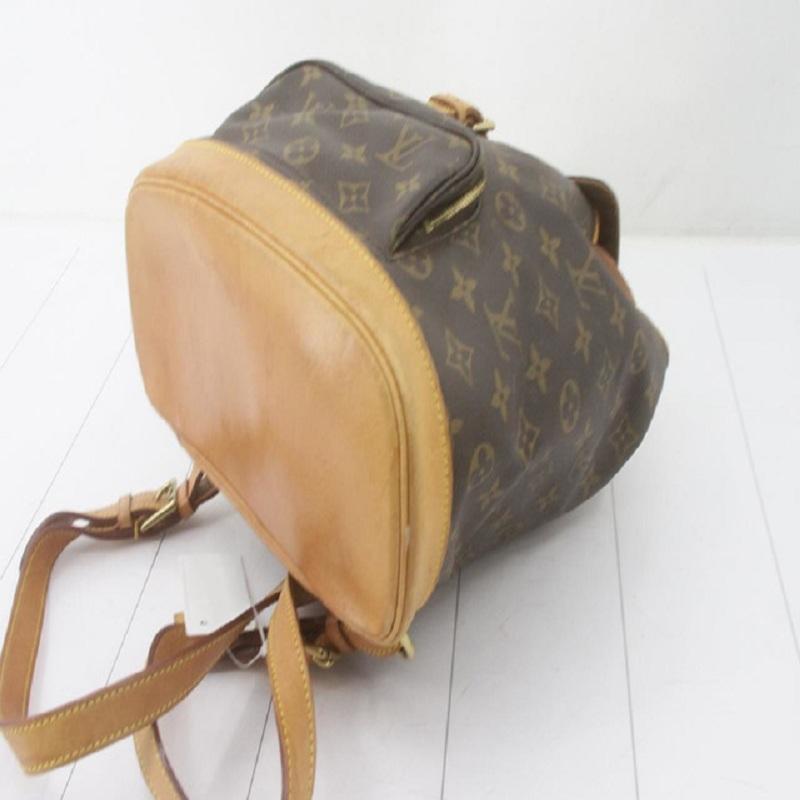 Brown and tan monogram coated canvas Louis Vuitton Montsouris MM with gold-tone hardware, tan vachetta leather trim, dual adjustable shoulder straps, single pocket at exterior with zip closure, brown canvas lining, single slit pocket at interior