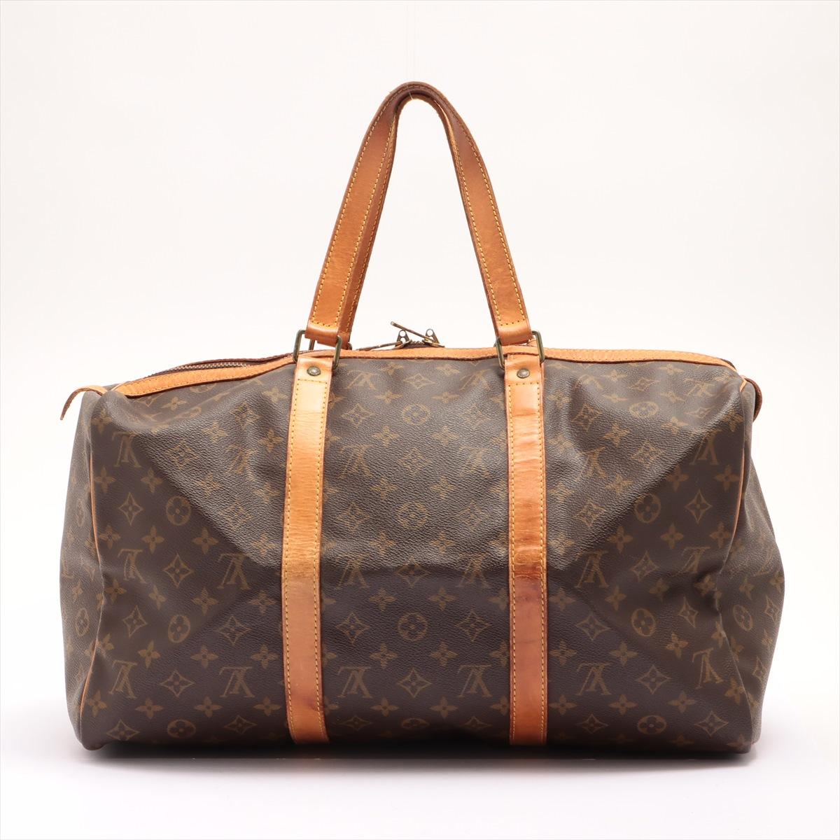 Brown and tan Monogram coated canvas Louis Vuitton Sac Souple 45 cm duffle bag with gold-tone hardware, tan vachetta leather trim, dual flat shoulder straps, brown canvas lining and two-way zip closure at top.

 

67908MSC