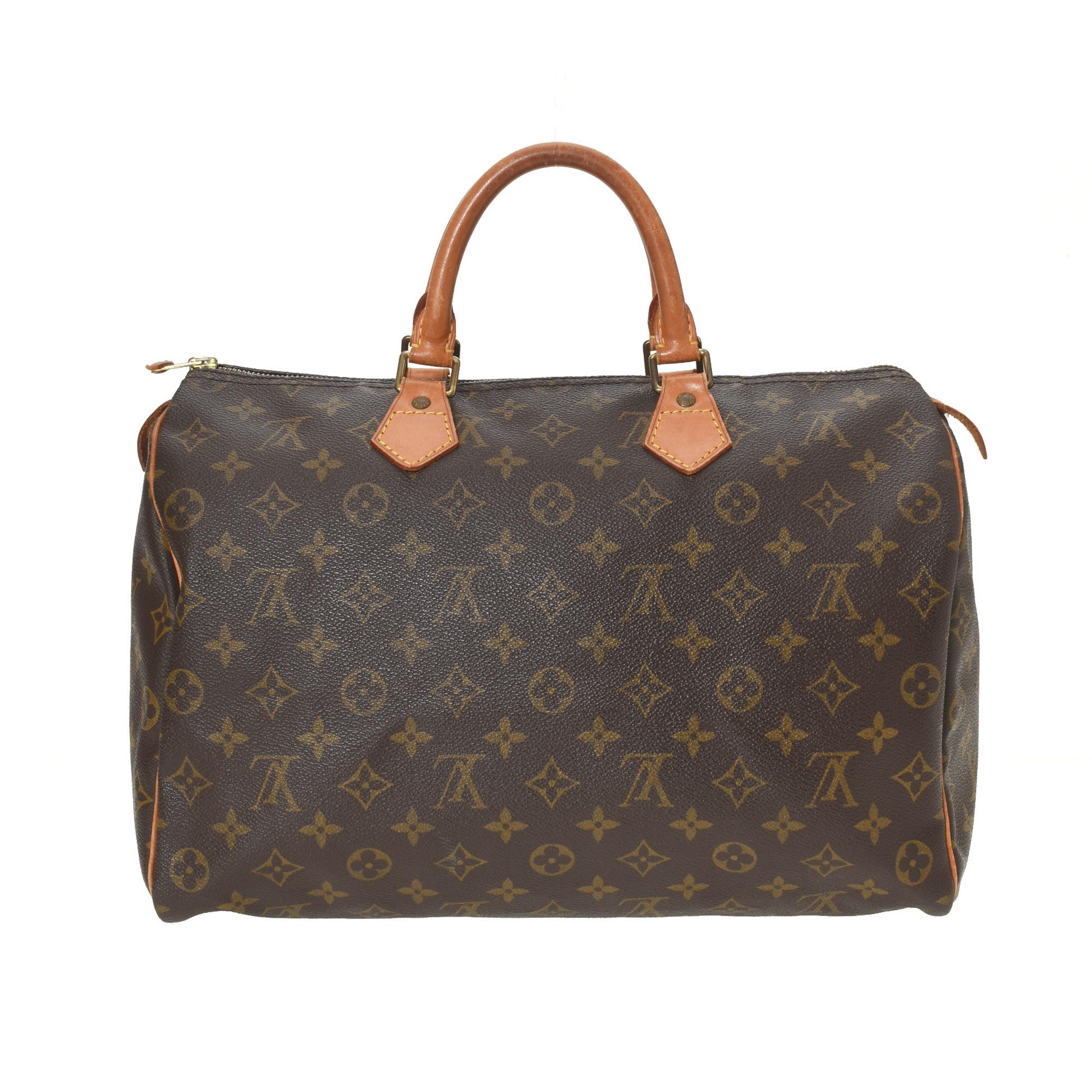 Brown and tan monogram coated canvas Louis Vuitton Speedy 35 with gold-tone hardware, tan Vachetta leather trim, dual rolled top handles, brown canvas lining, single slit pocket at interior wall and zip closure at top.


73317MSC

13.5
