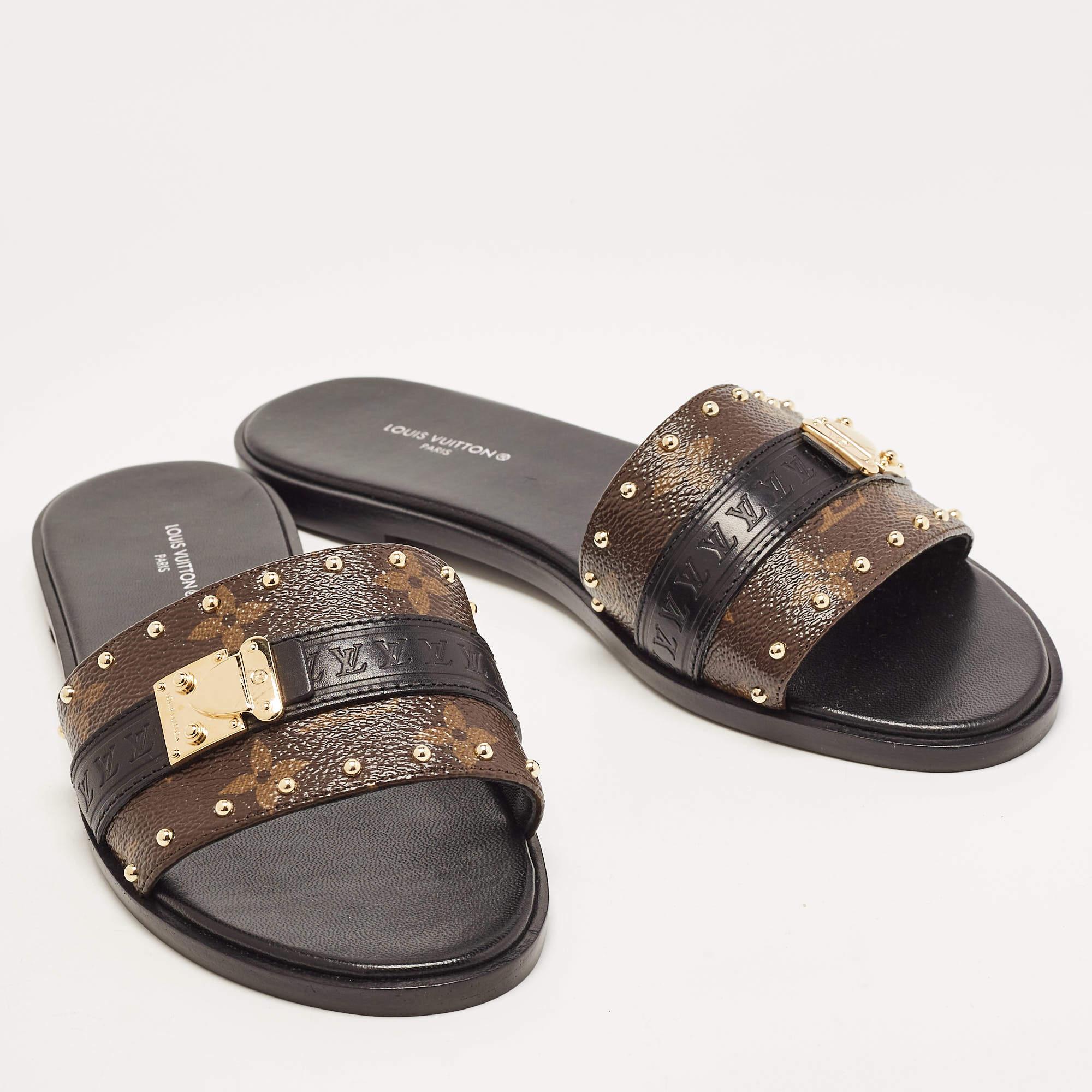 Present your feet with utmost comfort by choosing these 'Lock It' flat sandals from the iconic house of Louis Vuitton. They are crafted from the signature monogram canvas and detailed with two-tone 'LV' padlocks on the vamp straps. They are equipped