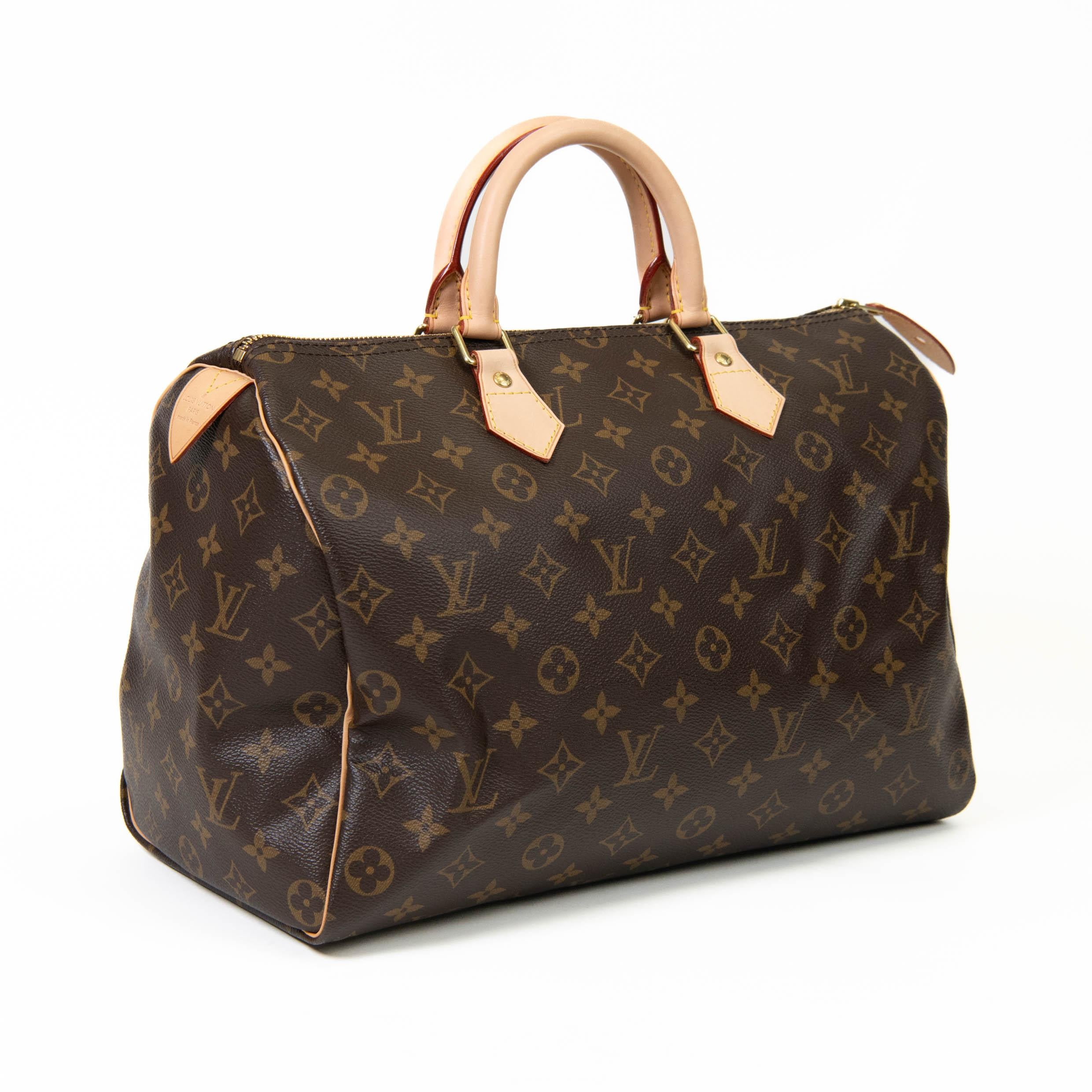 100% Authentic 

This classic, stylish handbag is crafted of traditional Louis Vuitton monogram coated canvas in brown. The bag features vachetta cowhide rolled leather trim and top handles with polished brass hardware. The top zipper opens to a