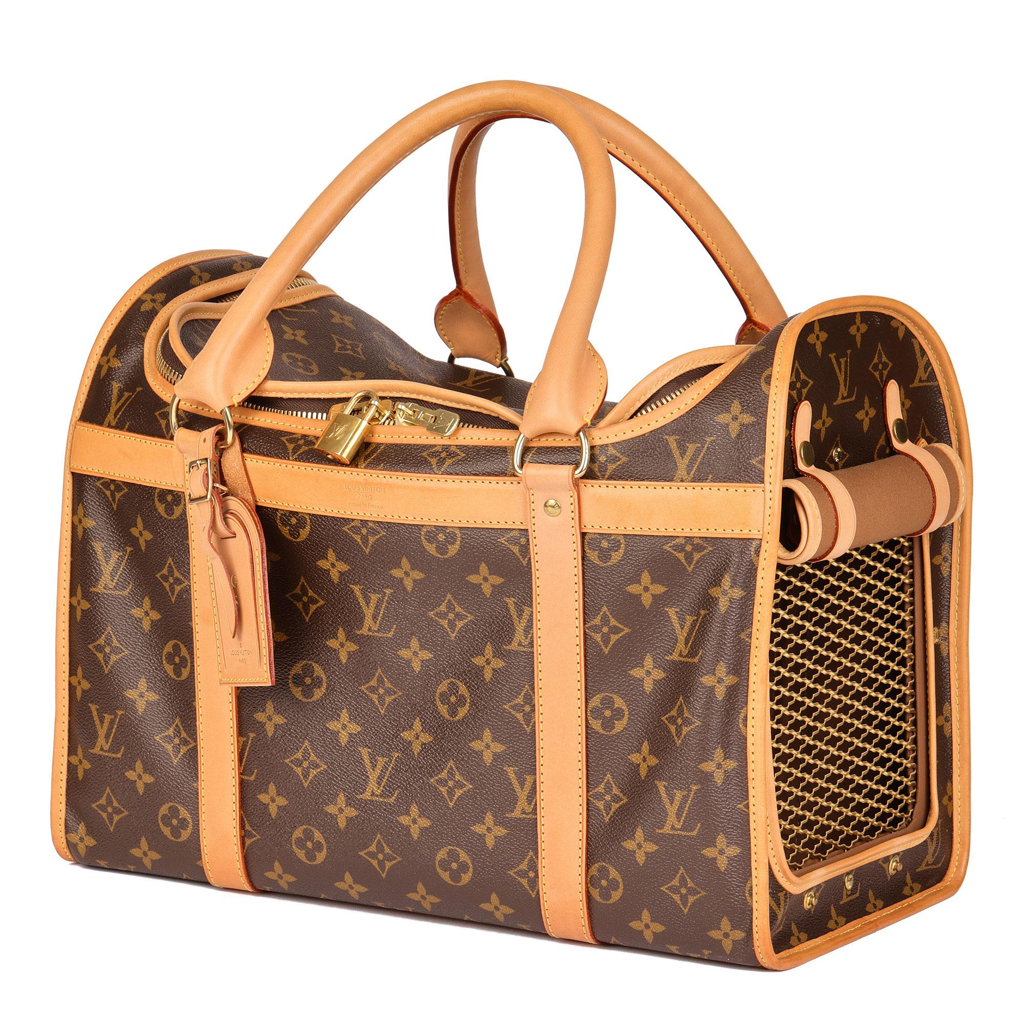 LOUIS VUITTON
Brown Monogram Coated Canvas & Vachetta Leather Sac Chien 40 Pet Carrier

Serial Number: TJ3191
Age (Circa): 2011
Accompanied By: Louis Vuitton Dust Bag, Padlock, Keys, Personalised Luggage Tag
Authenticity Details: Date Stamp (Made in