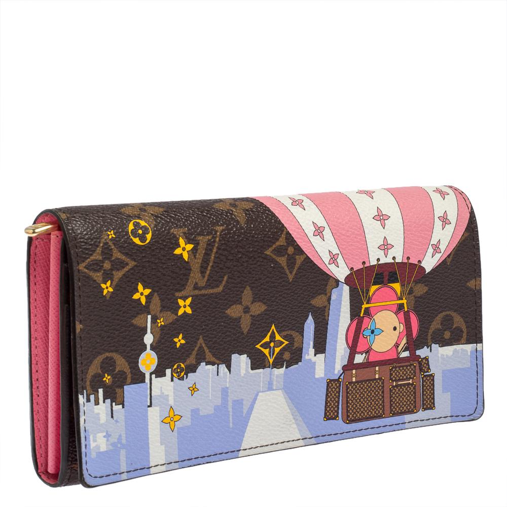 This Louis Vuitton 'Vivienne Shanghai' Sarah wallet is a special Holiday edition. It is crafted from monogram canvas and the button on the flap opens to an interior with multiple card slots and a zip pocket. Perfect in size, this wallet can easily