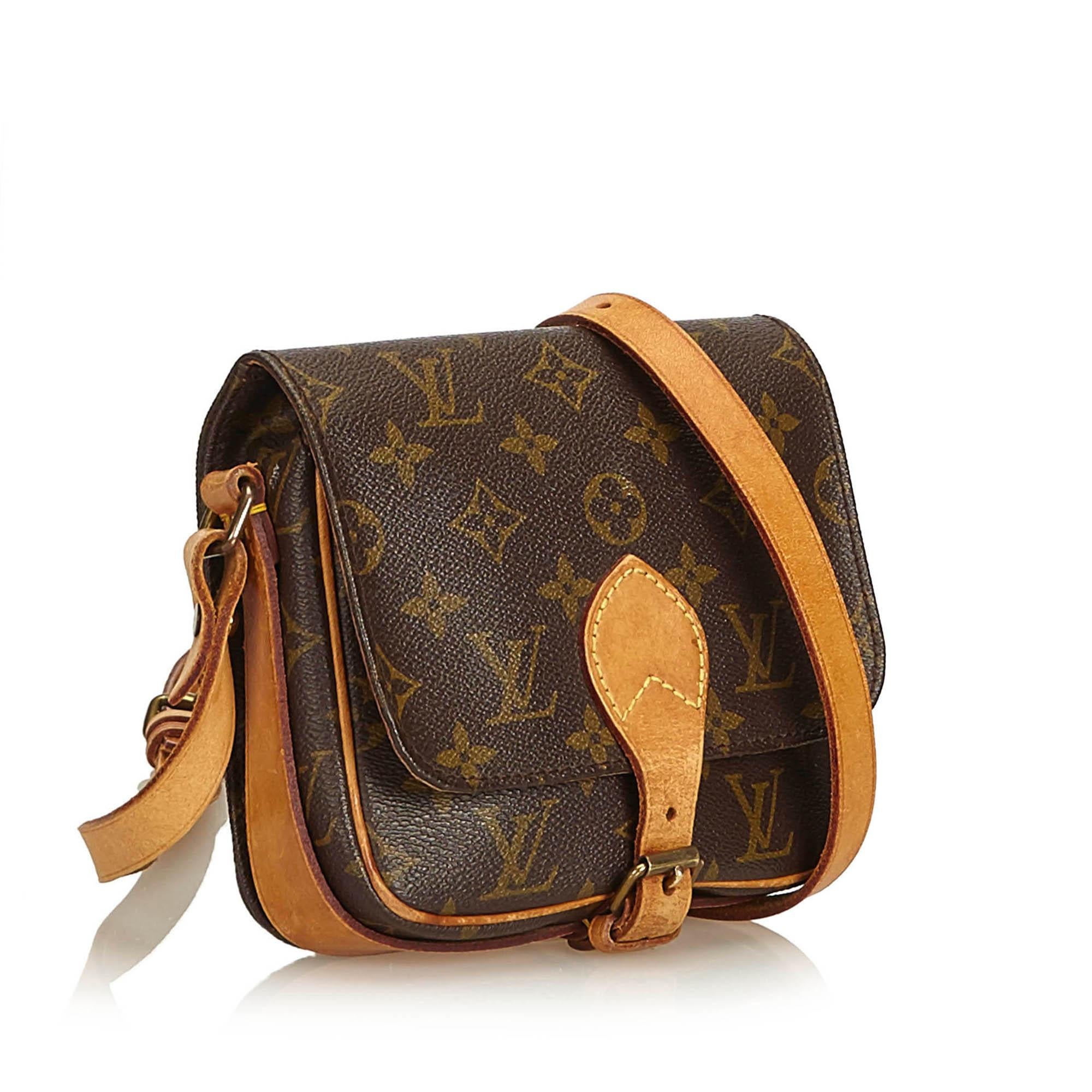 The Cartouchiere PM features the Monogram canvas, a front flap closure secured by a belt, an adjustable flat vachetta strap, vachetta piping and trim, and leather lining. It carries as B condition rating.

Inclusions: 
This item does not come with
