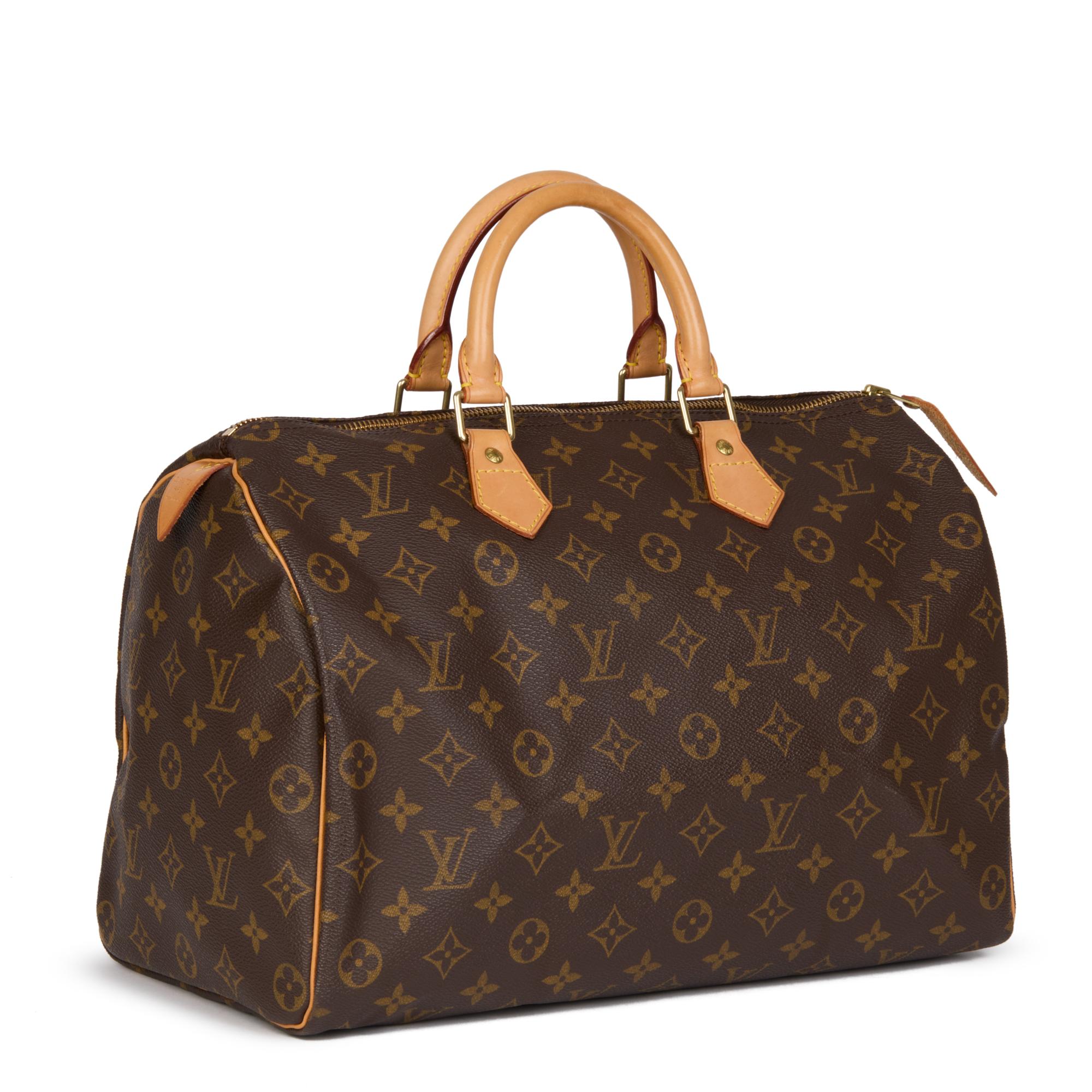 LOUIS VUITTON
Brown Monogram Coated Canvas & Vachetta Leather Vintage Speedy 35

Xupes Reference: HB4460
Serial Number: SP0948
Age (Circa): 1998
Authenticity Details: Date Stamp (Made in France) 
Gender: Ladies
Type: Tote

Colour: Brown 
Hardware: