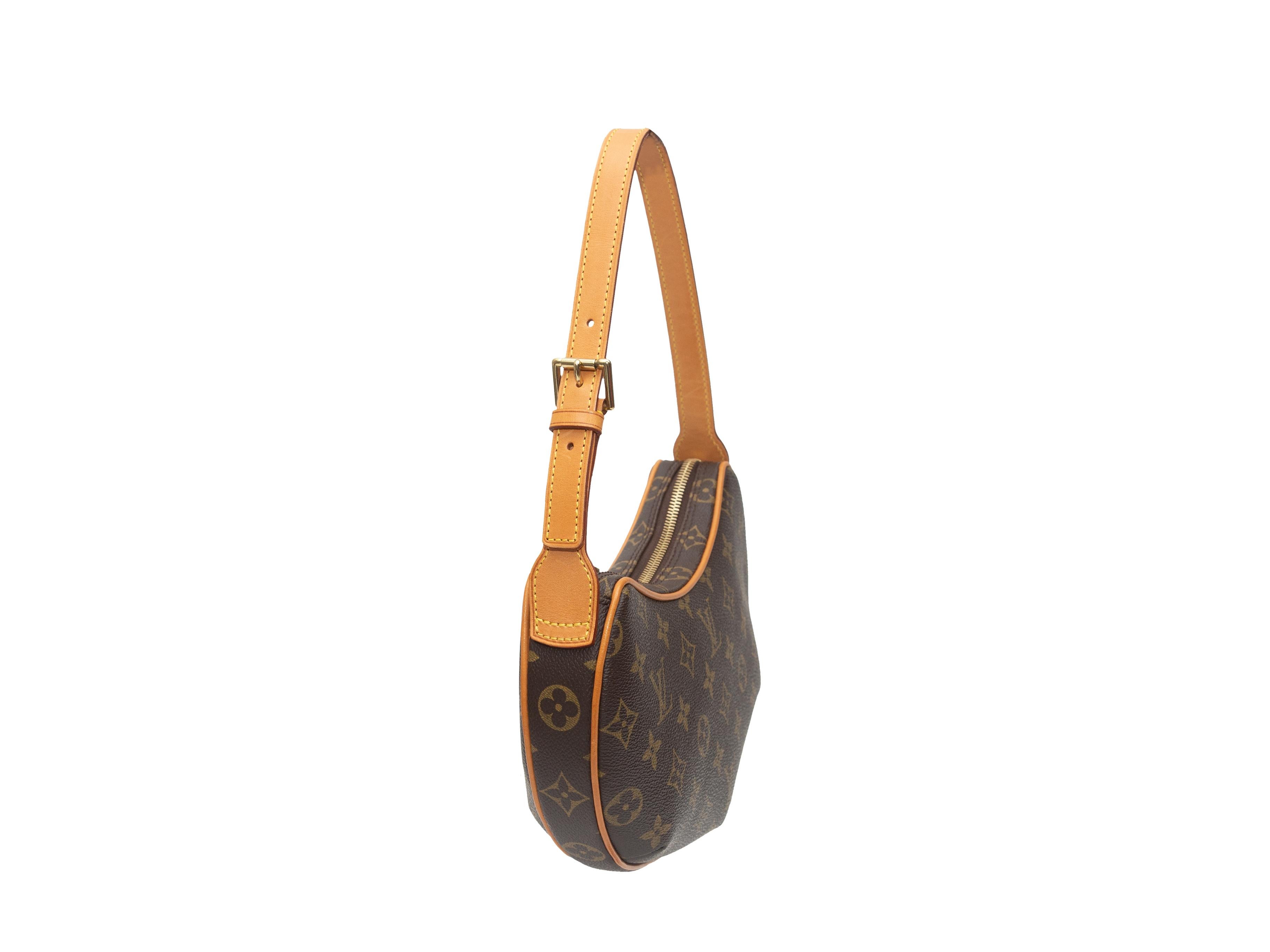 Product details: Vintage brown Monogram Croissant PM bag by Louis Vuitton. Circa 2003. Gold-tone hardware. Adjustable shoulder strap. Zip closure at top. 10.5