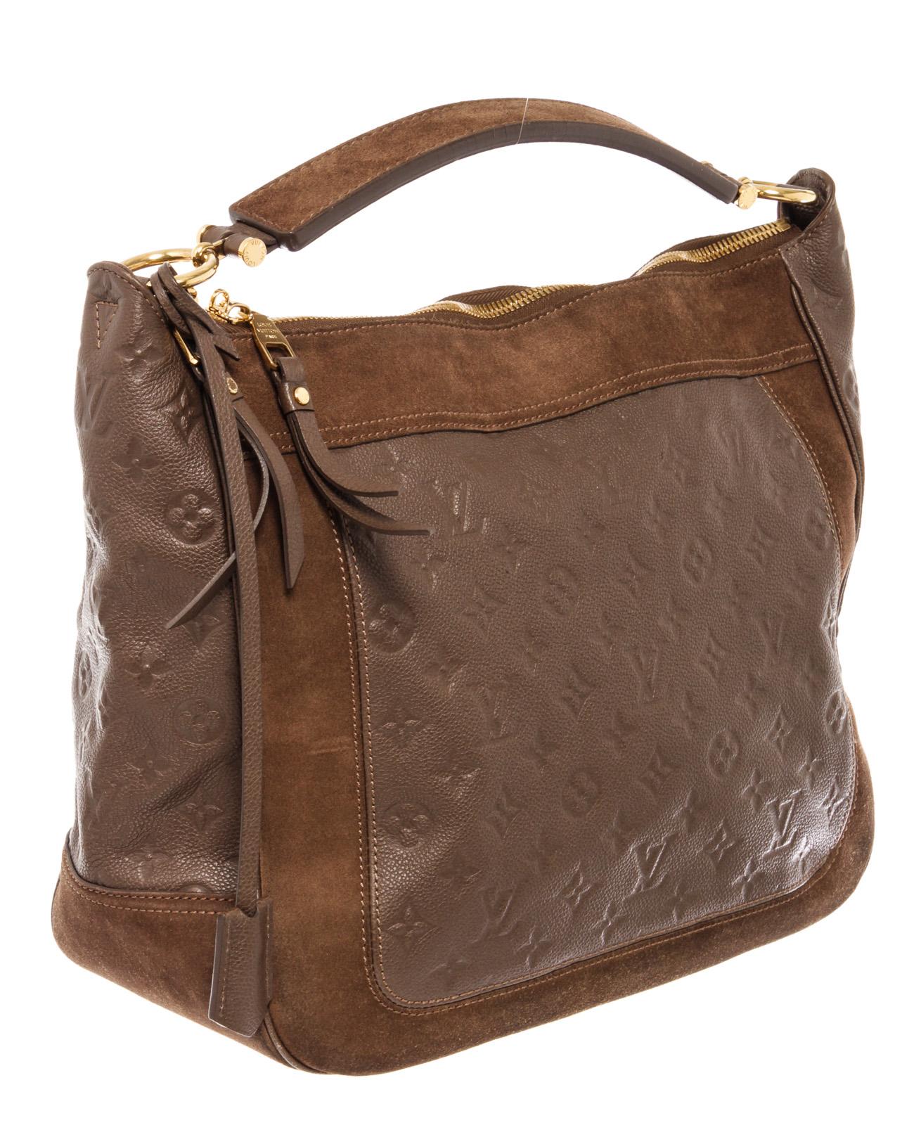 Louis Vuitton Audacieuse MM Bag is a unique combination of suede and embossed Empreinte leather in thick panels along with gold-tone hardware, two flat pockets, one zip pocket, flat leather shoulder strap and a removable, adjustable shoulder strap,