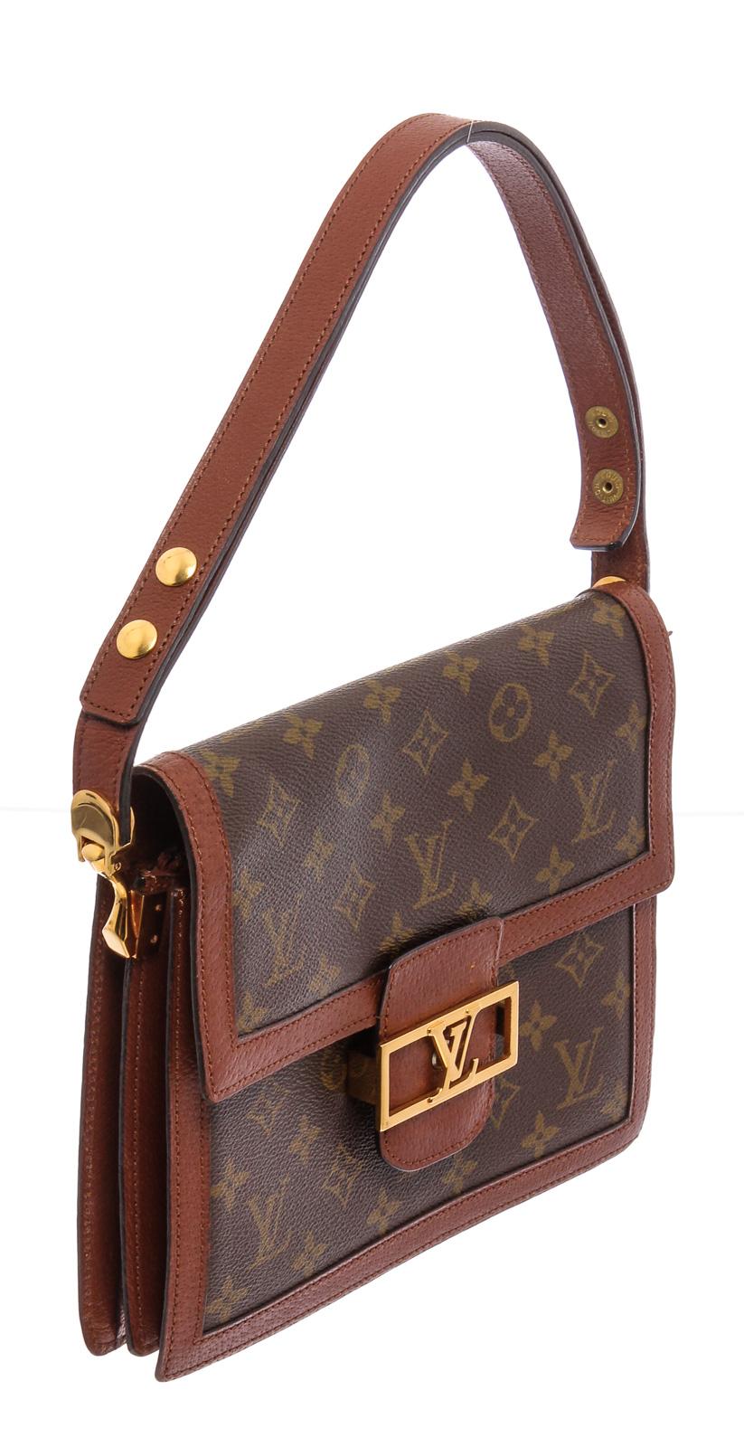 Brown leather Sac Dauphine shoulder bag from Louis Vuitton featuring a top handle, a foldover top with clasp closure, an internal slip pocket, an internal zipped pocket, an embossed internal logo stamp, a monogram pattern, gold-tone hardware, a