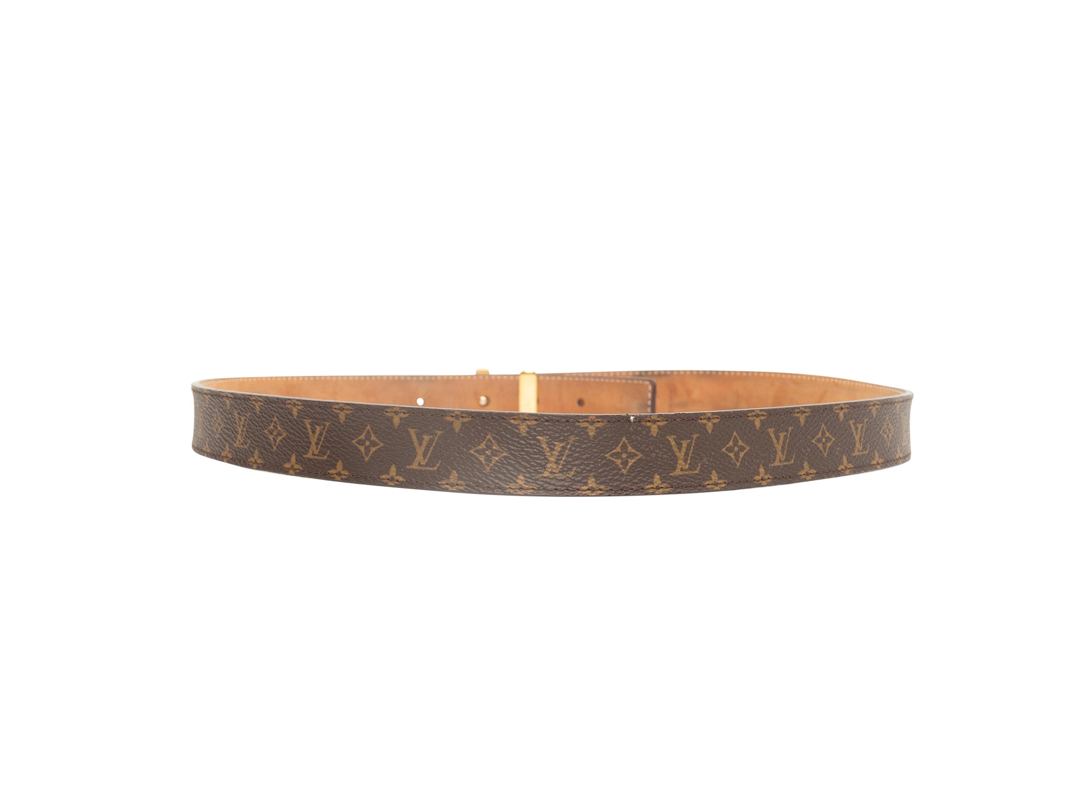 Product details: Brown monogram leather belt by Louis Vuitton. Gold-tone LV logo closure at front. 1