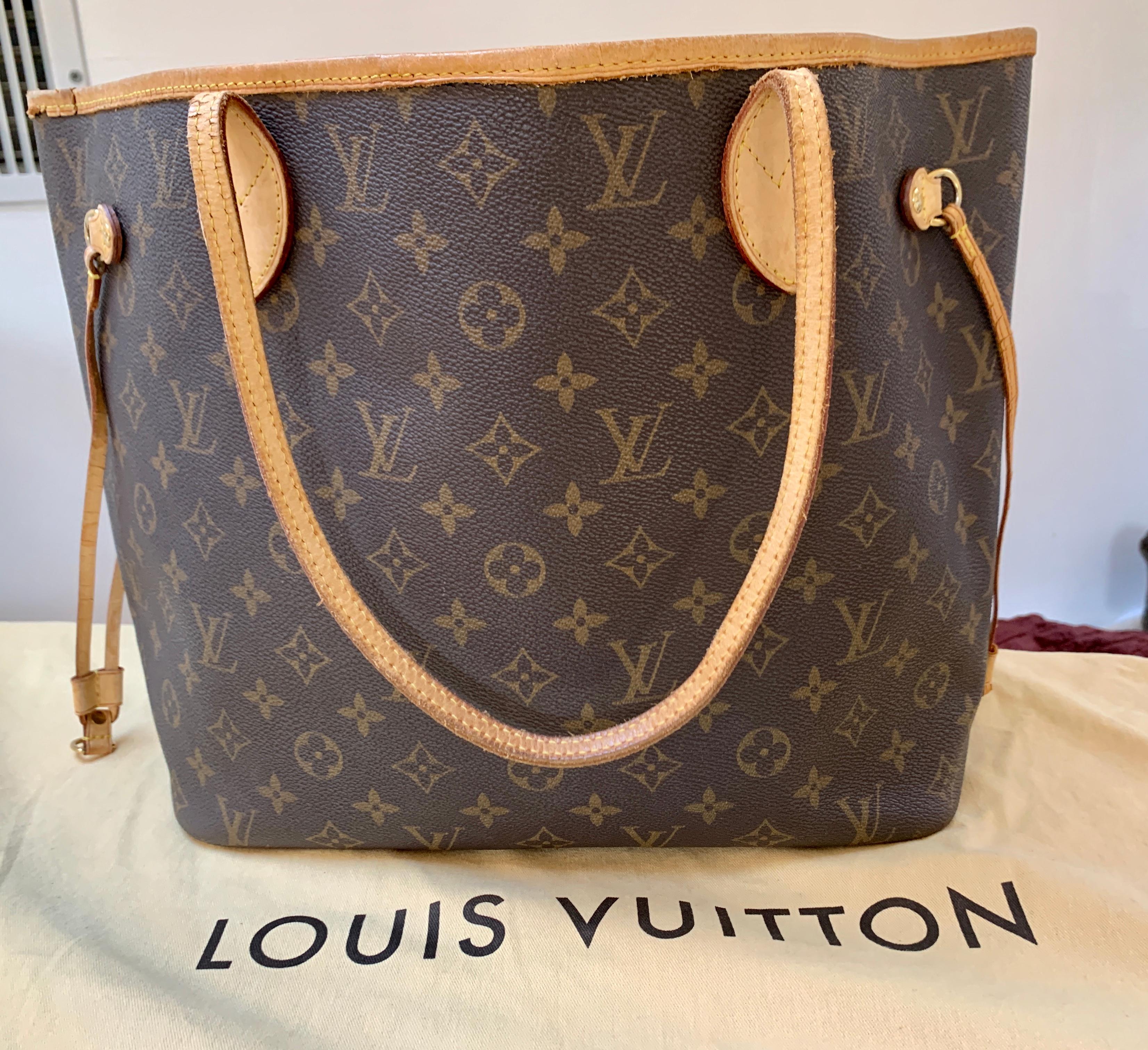 Brown and tan monogram coated canvas Louis Vuitton Neverfull MM with brass hardware, dual flat shoulder straps, tan Vachetta leather trim, drawstring accents at sides, tonal striped canvas lining, single zip pocket at interior wall and clasp closure