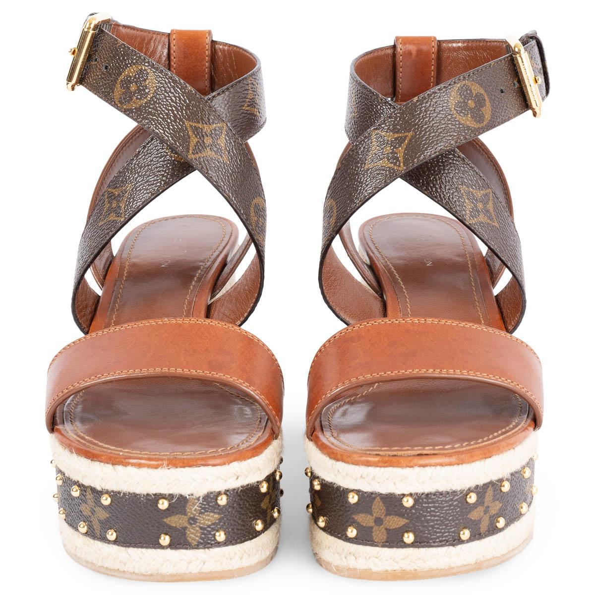 100% authentic Louis Vuitton Boundry wedge sandals in cognac leather brown Monogramm Canvas and raffia platform wedge. Buckle fastening at ankle featuring gold-tone studs. Have been worn and are in excellent condition. 

Measurements
Shoe