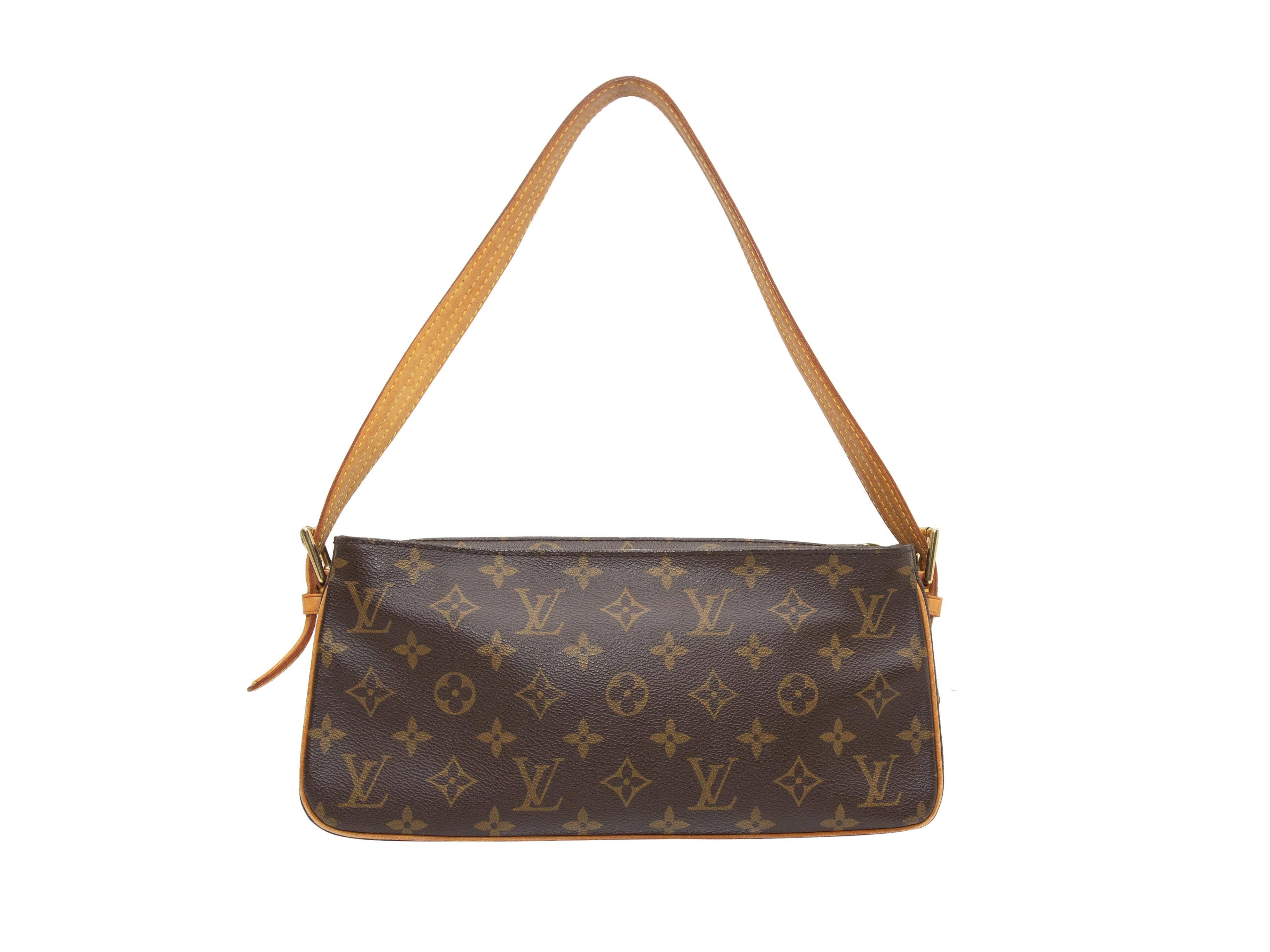 Product details: Brown and tan Monogram Viva Cite MM bag by Louis Vuitton. Single shoulder strap. Dual exterior pockets. Zip closure at top. 12