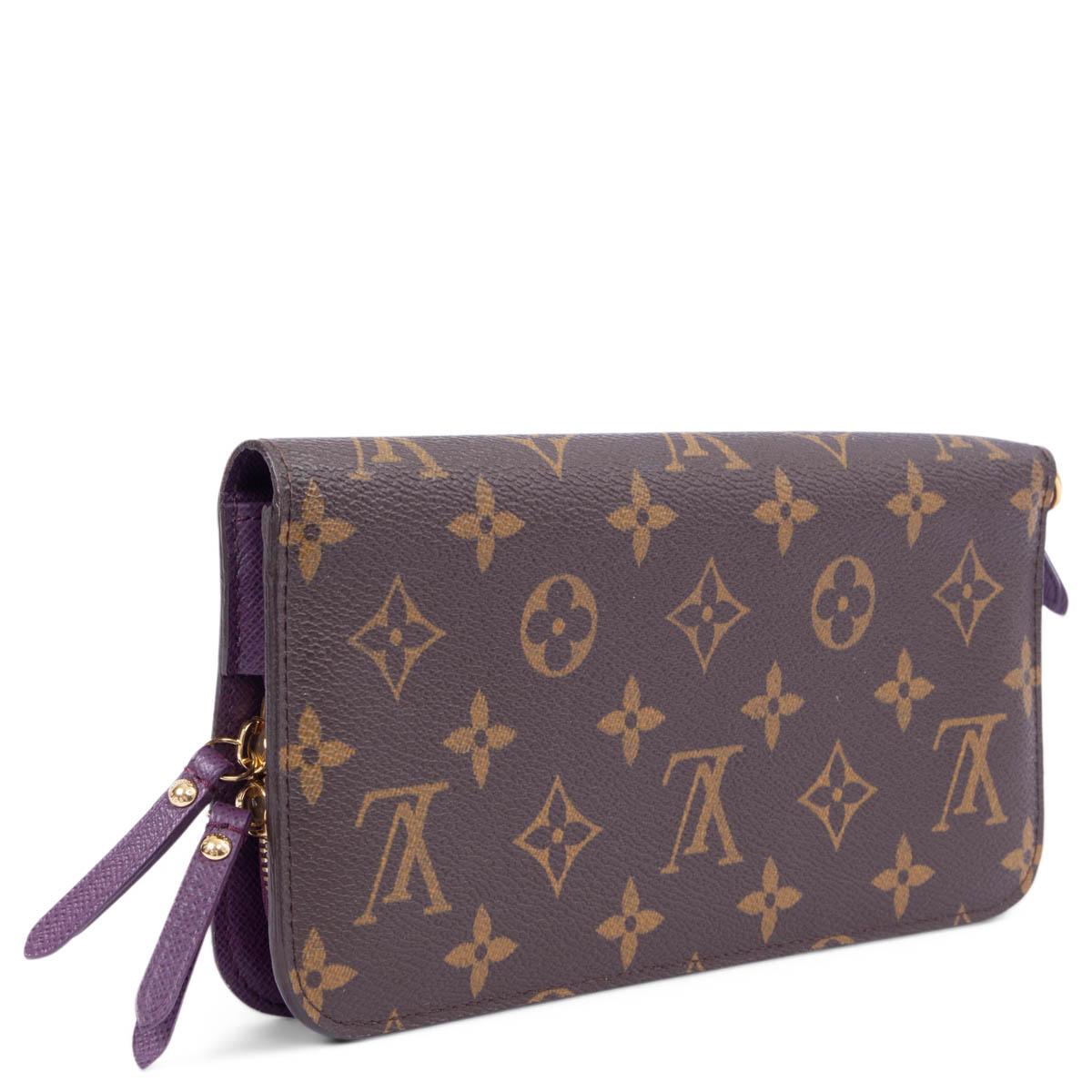 100% authentic Louis Vuitton Insolite Monogram Canvas wallet in brown featuring gold-tone hardware. Opens with push-buttons to a purple lined interior with twelve credit card slots, two bill compartments and two zipped coin pockets. Has been carried