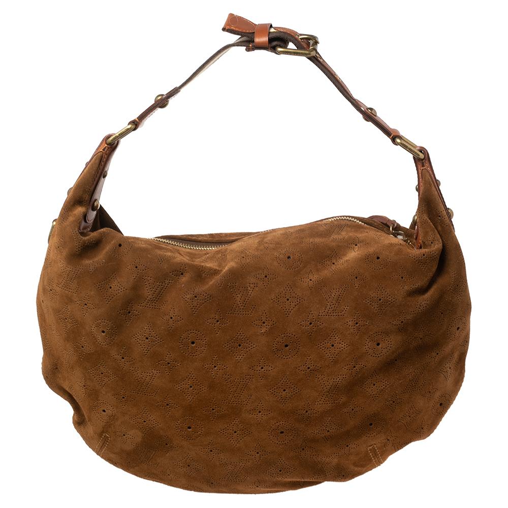 This beautifully stitched suede hobo is by Louis Vuitton. With a capacious fabric-lined interior, a comfortable handle, and a fine finish, this brown hobo is bound to offer style and practical ease.

Includes: Info Booklet, Brand Dustbag