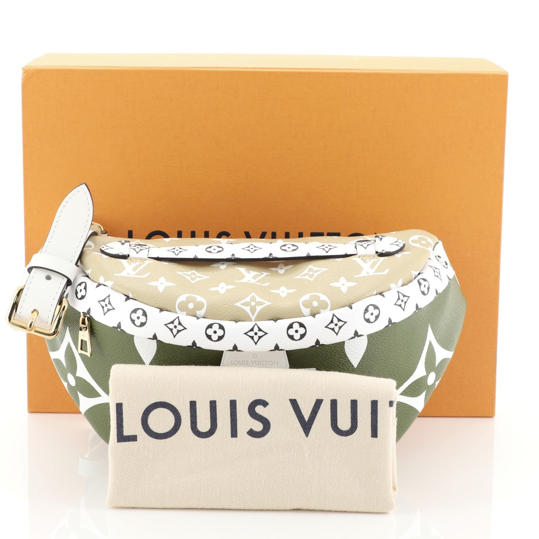 This Louis Vuitton Bum Bag Limited Edition Colored Monogram Giant, crafted in green and neutral monogram coated canvas, features an adjustable belt strap, top handle, and gold-tone hardware. Its zip closure opens to a neutral fabric interior with