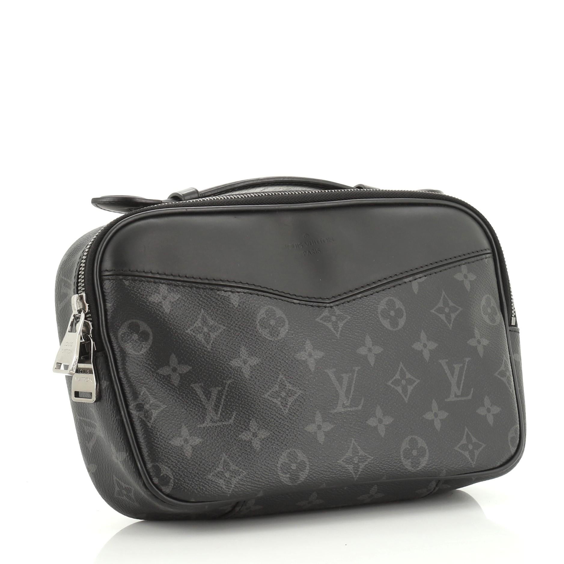 This Louis Vuitton Bum Bag Monogram Eclipse Canvas, crafted from monogram eclipse coated canvas, features an adjustable strap, leather top handle, exterior zip pockets, and silver-tone hardware. Its zip closure opens to a black fabric interior with