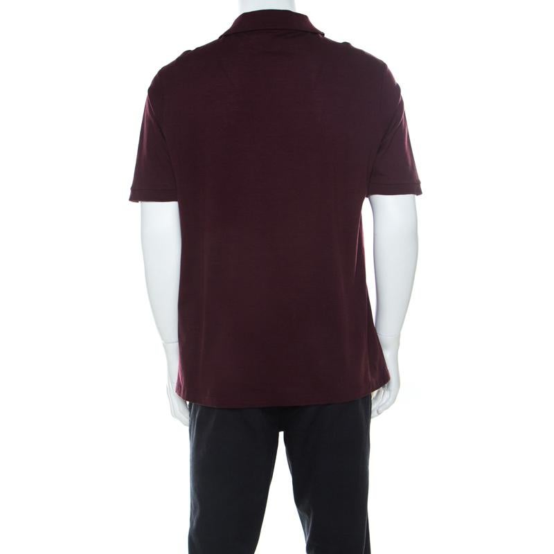 Made from soft and breathable cotton, this short-sleeved polo T-shirt by Louis Vuitton is styled with buttons and a honeycomb pattern adorned all over. The burgundy hue lends a smart touch to the shirt, making it ideal for casual outings.



