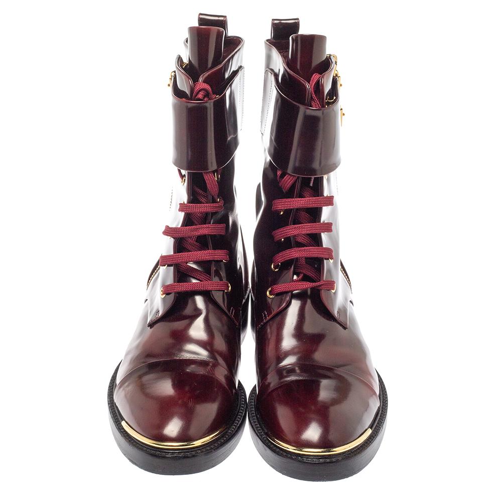 These Diplomacy Ranger boots combine form and function. This glossy pair is crafted in burgundy-hued leather featuring a gold-tone toe cap detail, side zipper, and eyelets on the lace-up front. The strap closure with buckles ensures a secure fit.