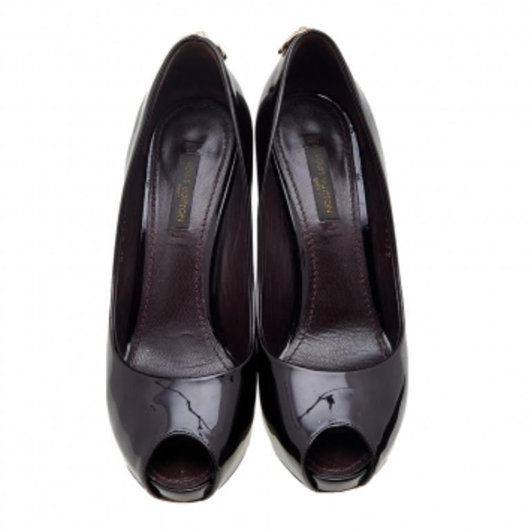 Classy in burgundy, these pumps from Louis Vuitton come crafted from patent leather into a peep-toe silhouette. The pumps are equipped with comfortable leather-lined insoles, platforms, and 14 cm heels. They are highlighted with a gold-tone padlock