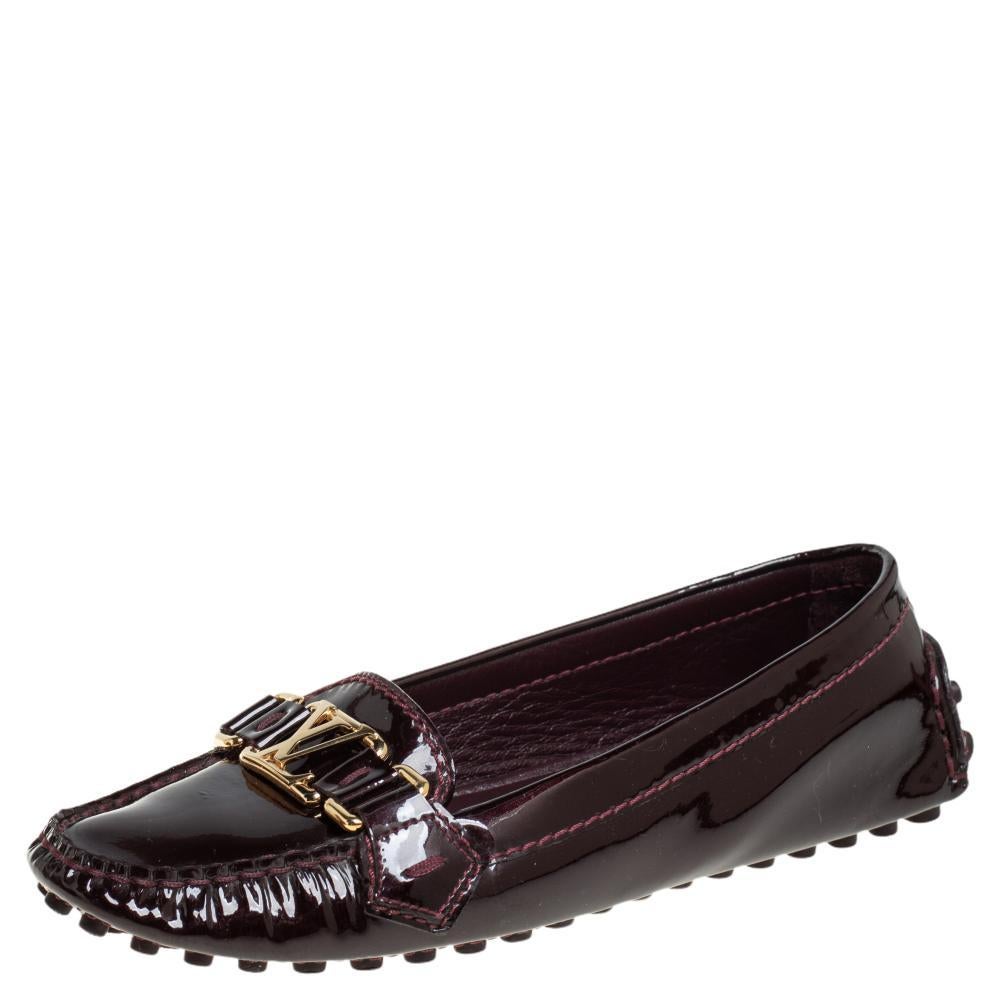 Louis Vuitton's loafers are loved by men and women worldwide as they are perfect for making a fashion statement. These burgundy loafers are crafted from patent leather and feature a chic design. They flaunt round toes, LV motifs on the vamps,