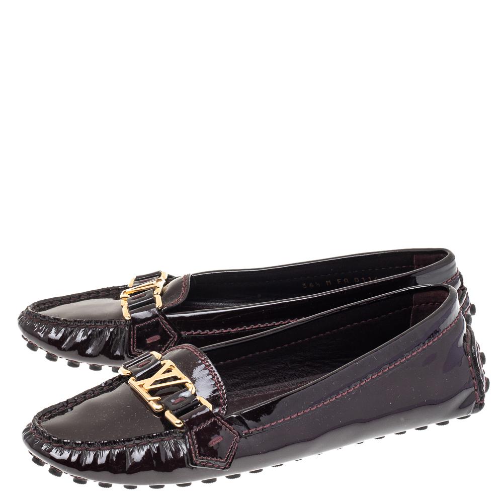 Louis Vuitton's loafers are loved by men and women worldwide as they are perfect for making a fashion statement. These burgundy loafers are crafted from patent leather into a chic design. They flaunt round toes, LV motifs on the vamps, comfortable