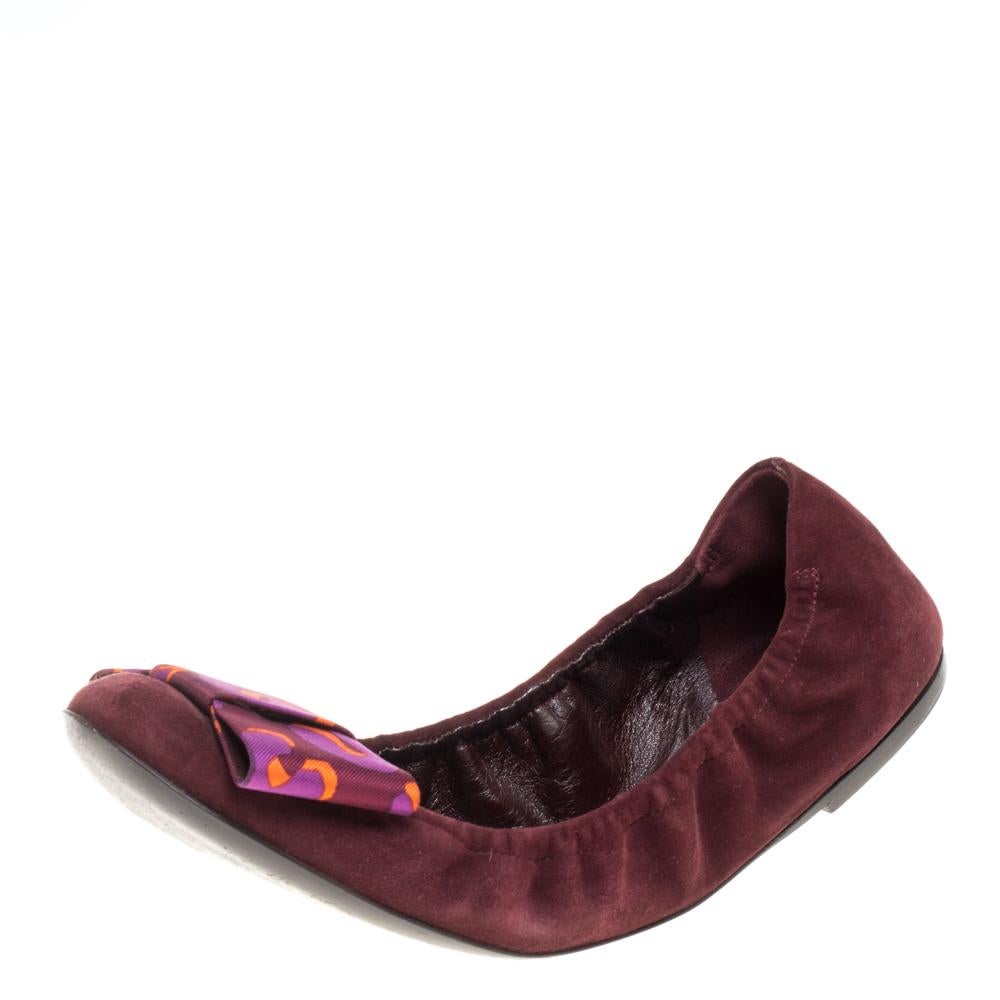 These magnificent flats from Louis Vuitton are designed to complement your entire outfit. Crafted from burgundy-hued suede, these ballerina flats exude class. They feature round toes accented with printed bow detail, leather lining, and soles.

