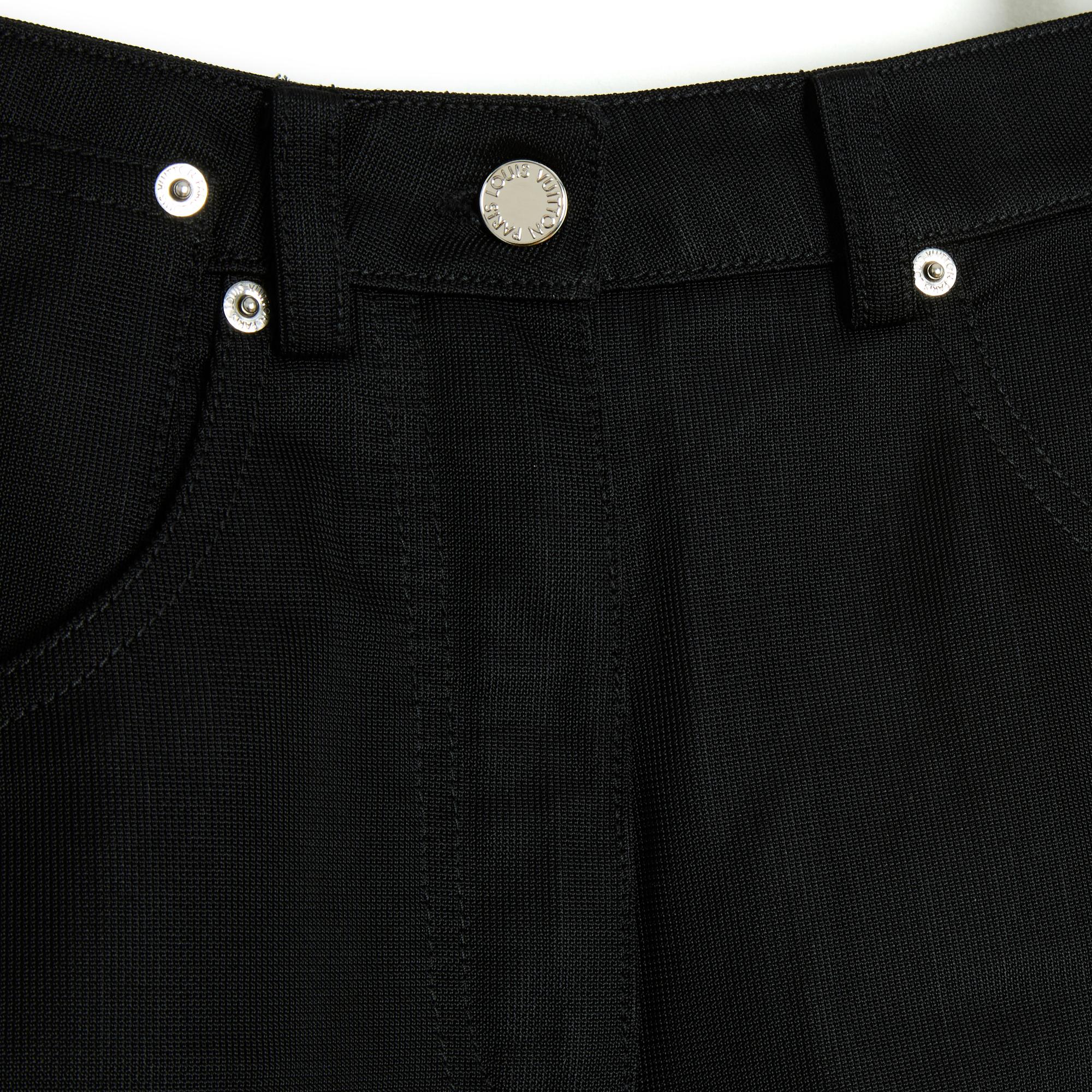 Louis Vuitton mini shorts by Nicolas Ghesquière (circa 2016) in black jersey (both soft and rigid), 2 large jean pockets on the front, one with an additional mini pocket and 2 large jean pockets on the back, the studs, button and zip are in silver