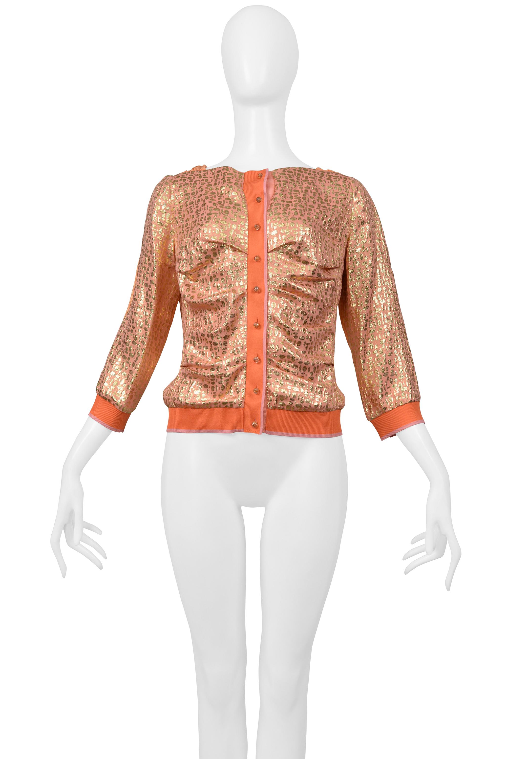 Resurrection Vintage is excited to offer a vintage Louis Vuitton by Marc Jacobs gold and coral cardigan top featuring a delicate gold pebble print, a gathered front, center front buttons, a cowl back, and 3/4 sleeves.

Louis Vuitton
Designed By Marc